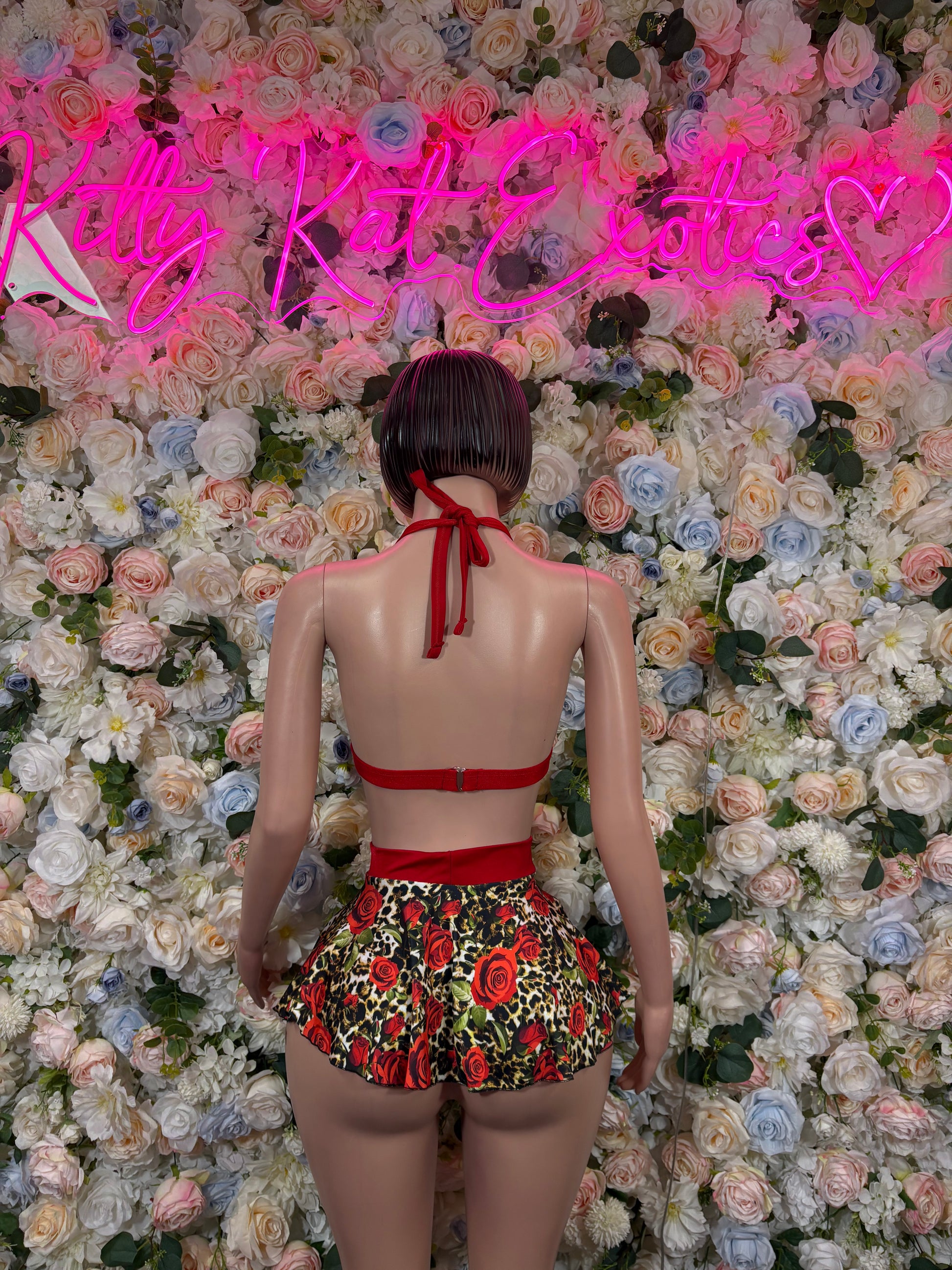 Rose print skirt set back view: red string bra and black floral rose ruffle skirt