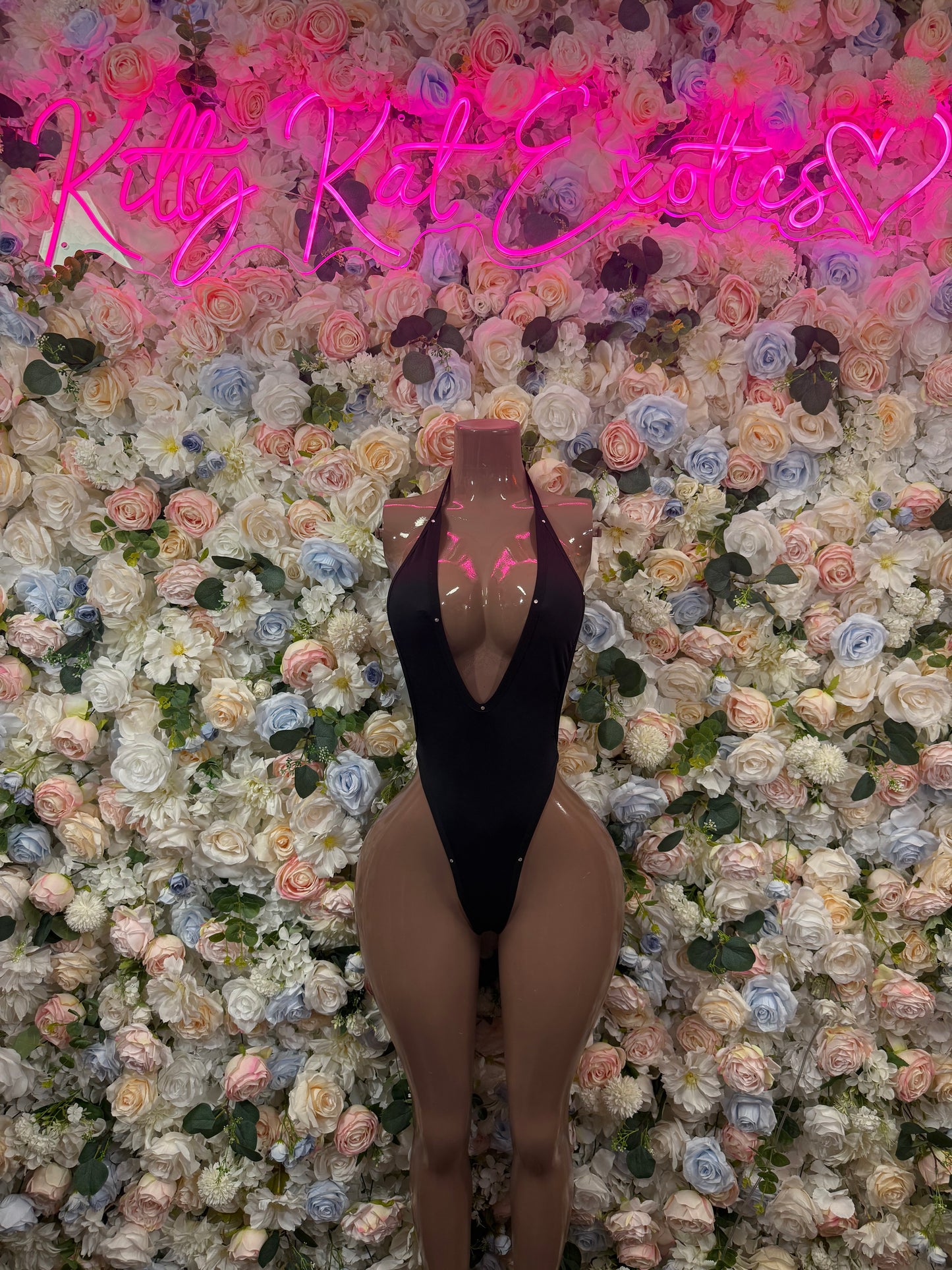 Black one-piece bodysuit with deep V back and high-cut legs