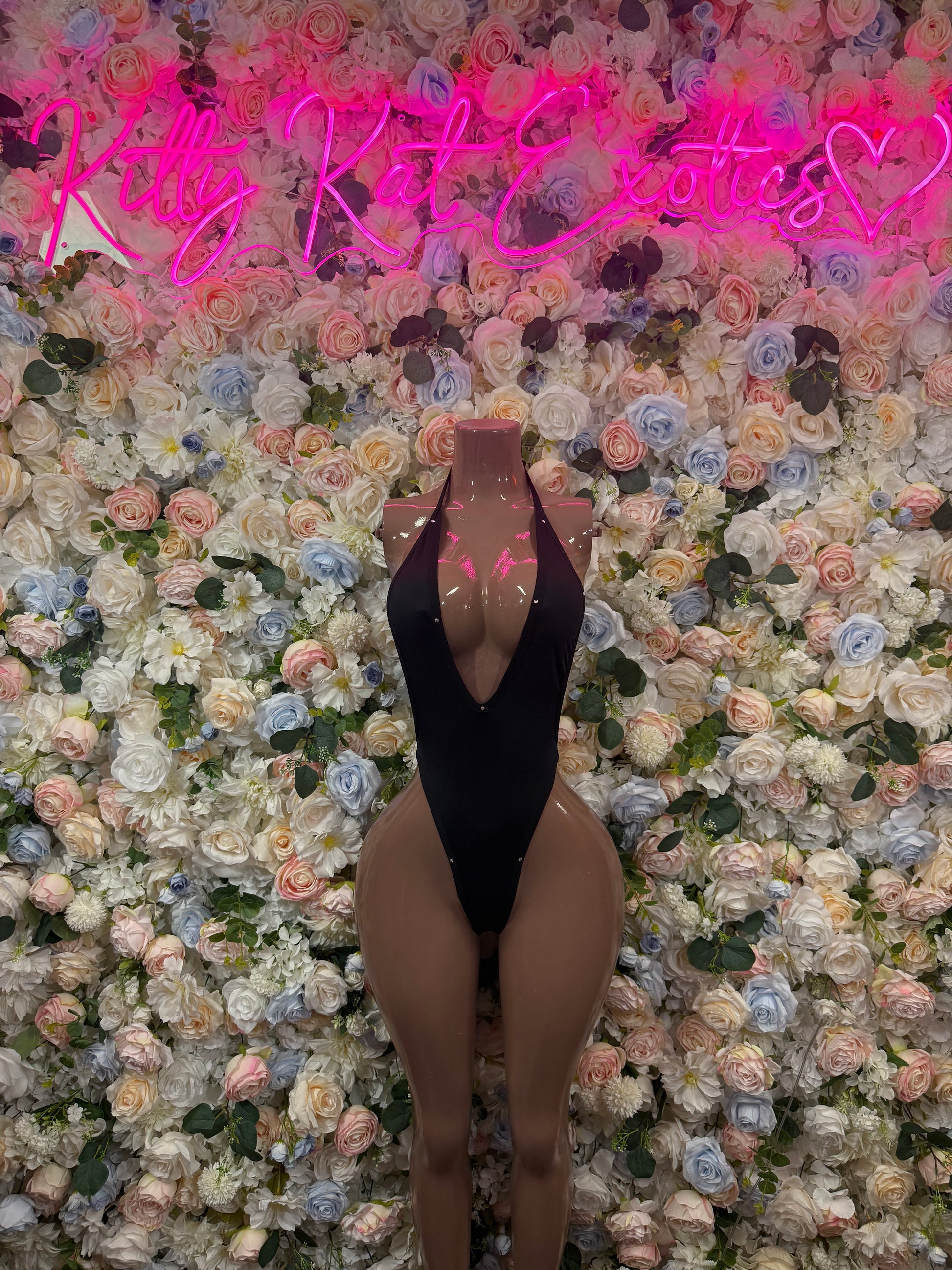 Black one-piece bodysuit with deep V back and high-cut legs