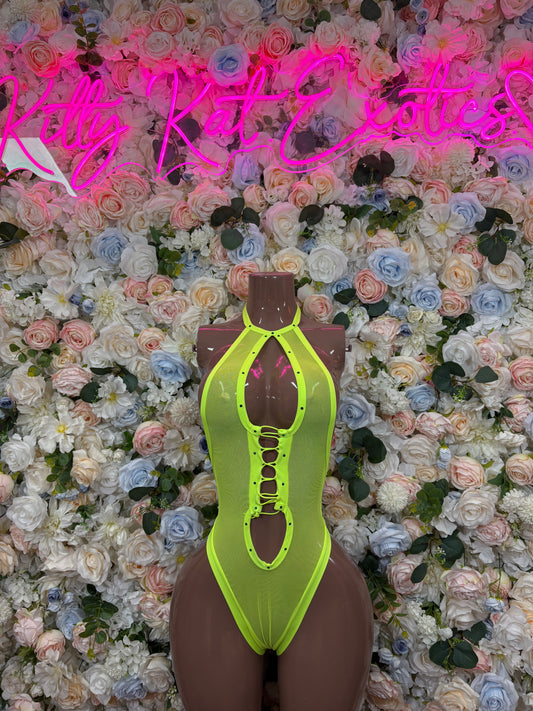 Neon green bodysuit with oval chest cutout, lace-up detailing, and high-cut legs