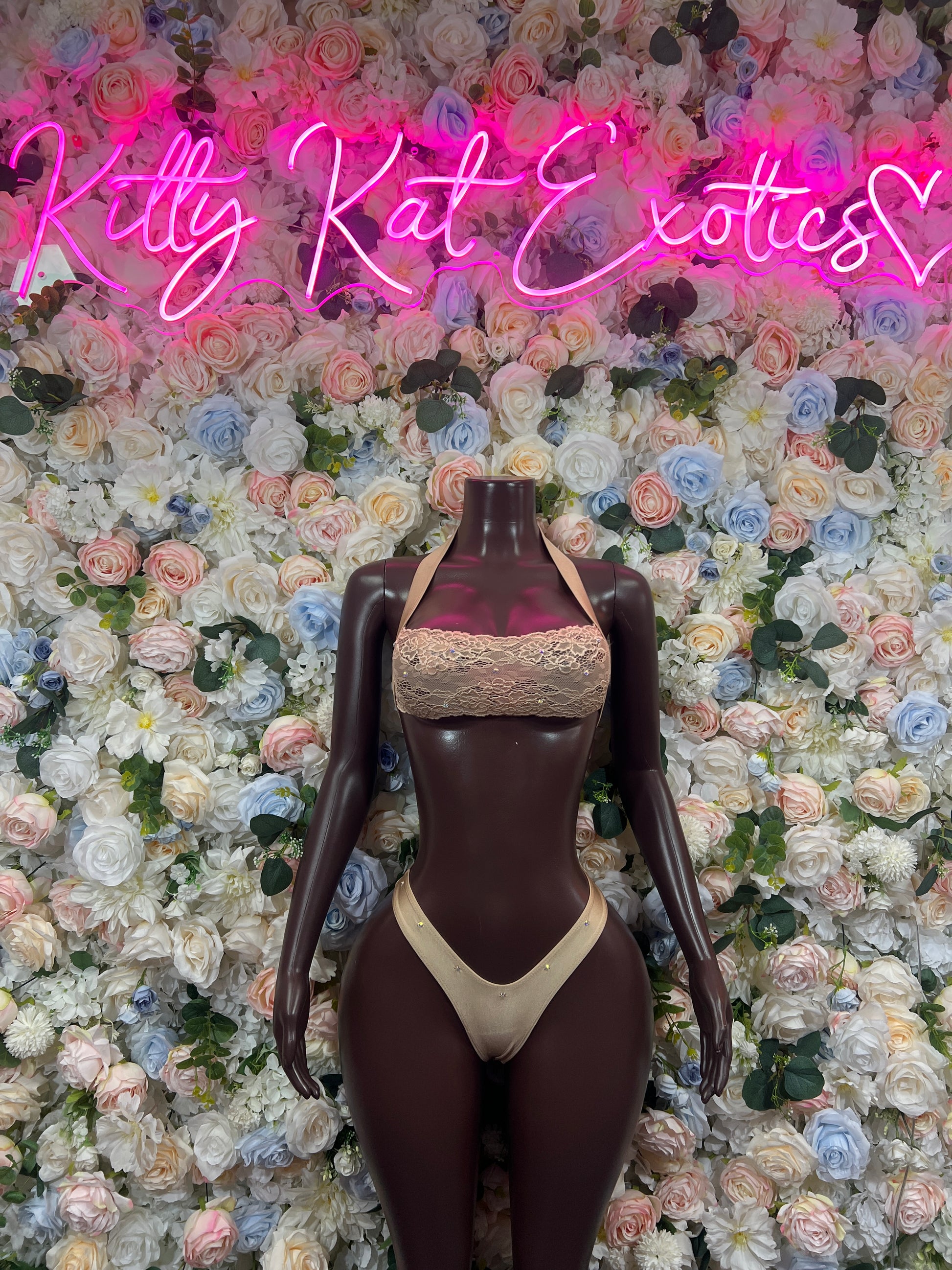 Beige triangle bikini top and thong bottom on dark mannequin