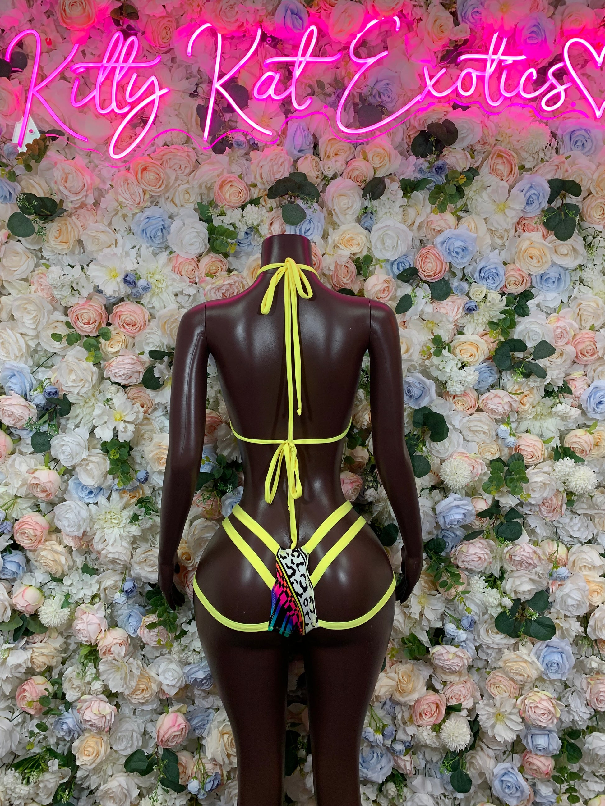 Dark brown long-sleeve two-piece bodysuit with neon green straps and multicolor accent