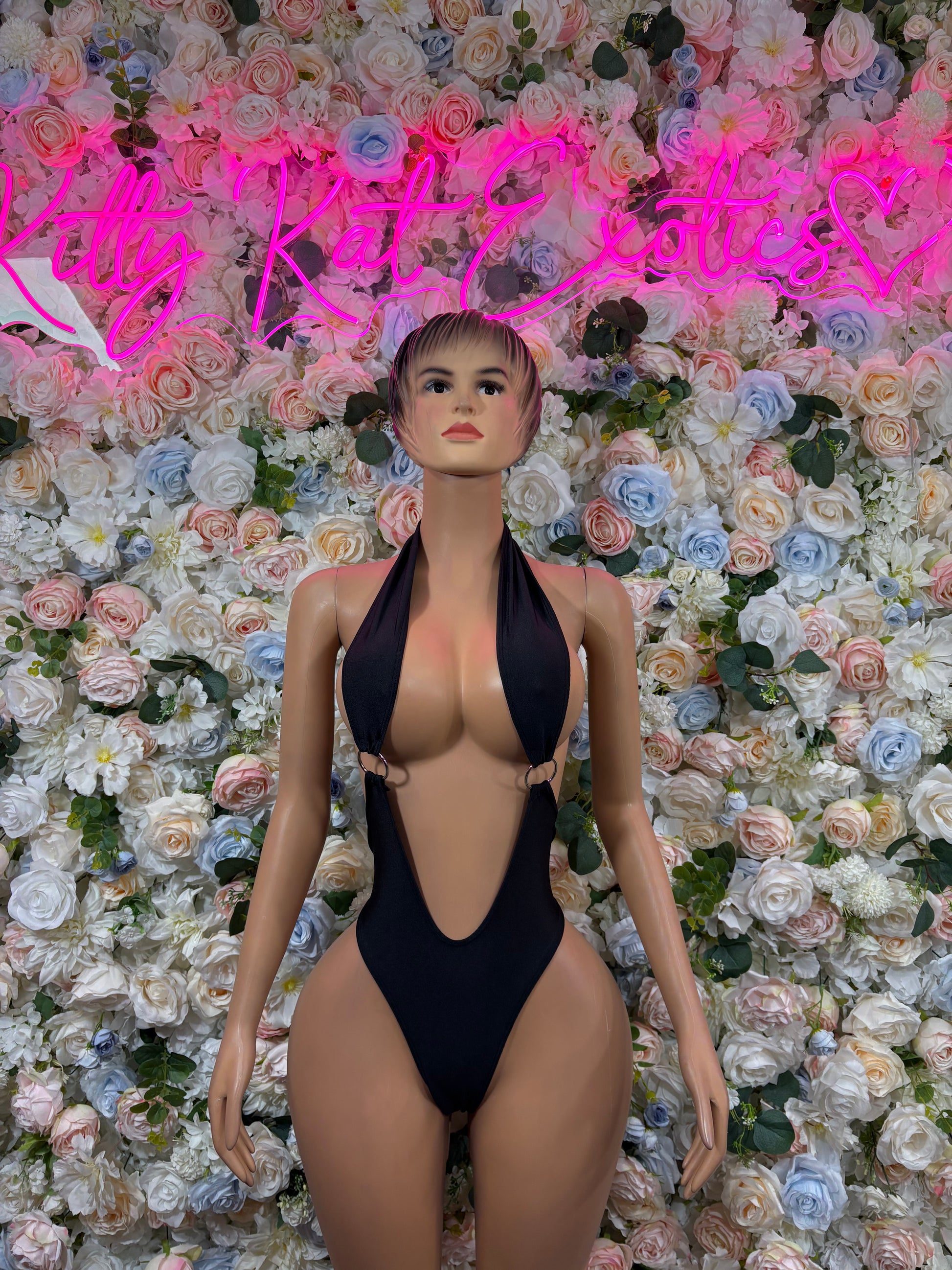 Black halter bodysuit with deep V neckline and open back, one-piece dancewear.
