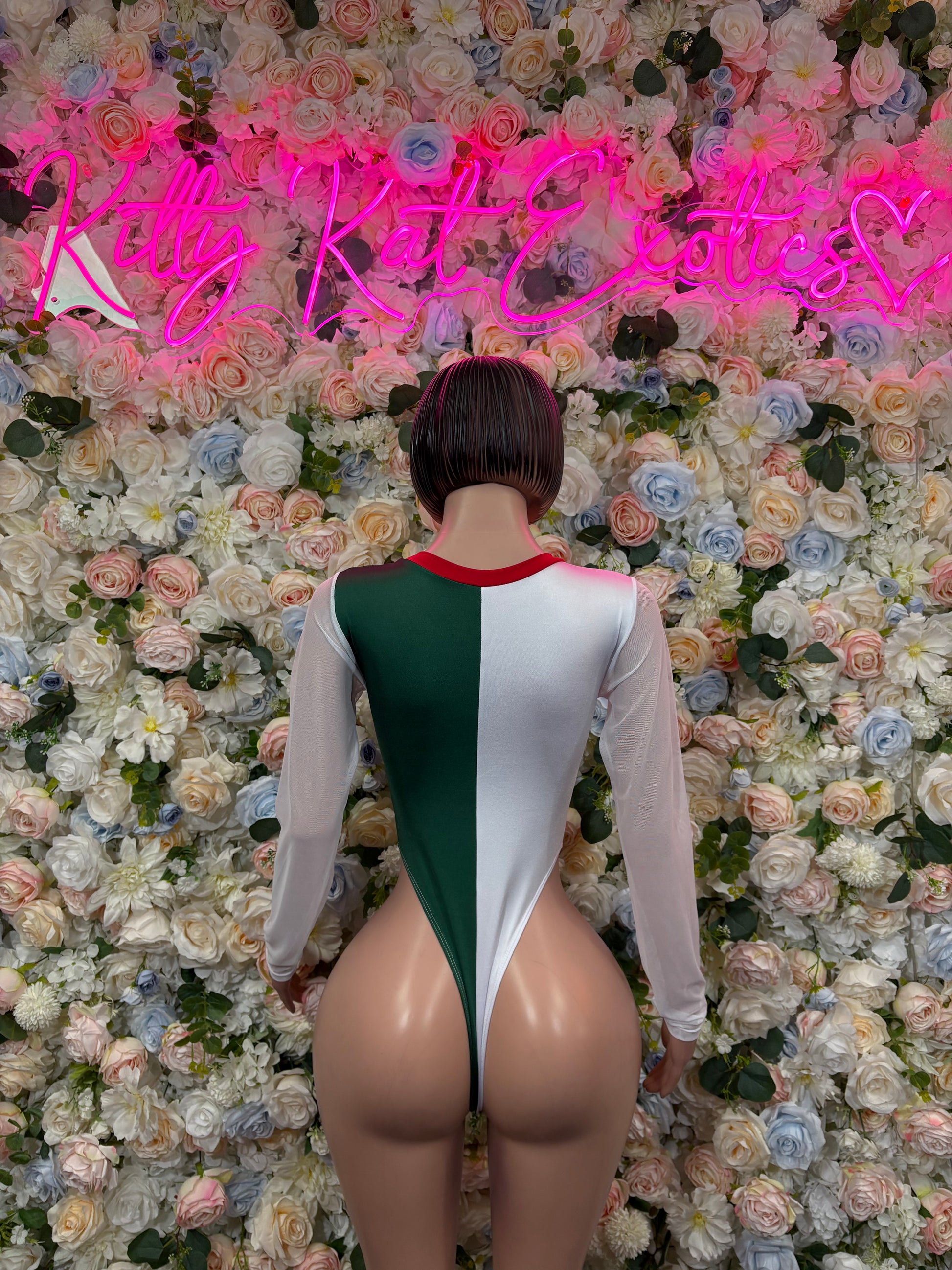 Women’s bodysuit back view with green vertical panel and white long sleeves