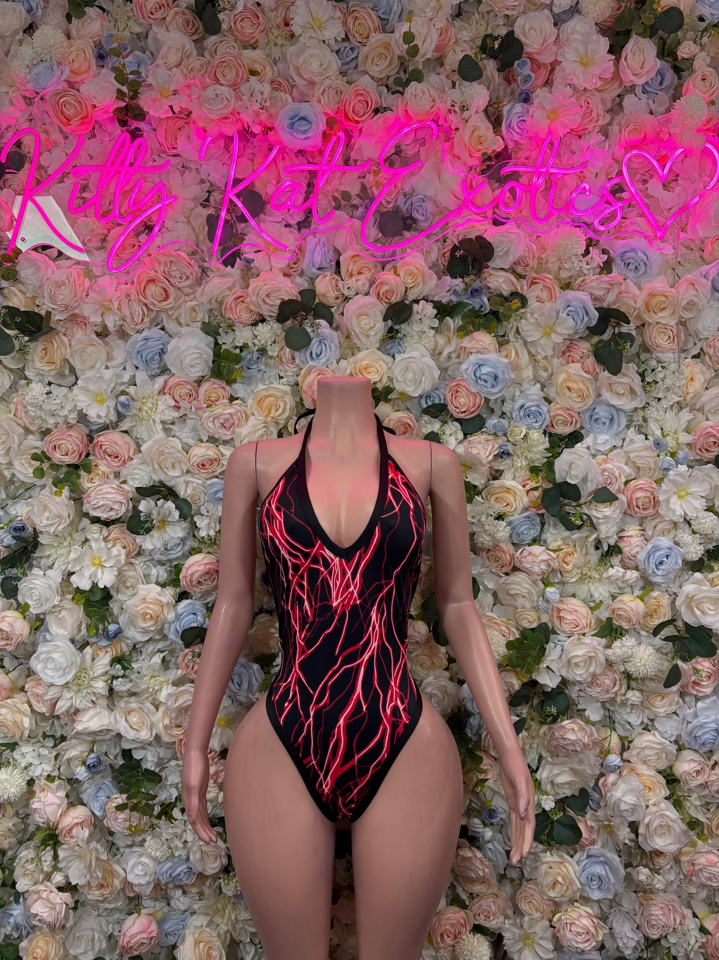 Red and black one-piece bodysuit with neon line print and deep V neckline