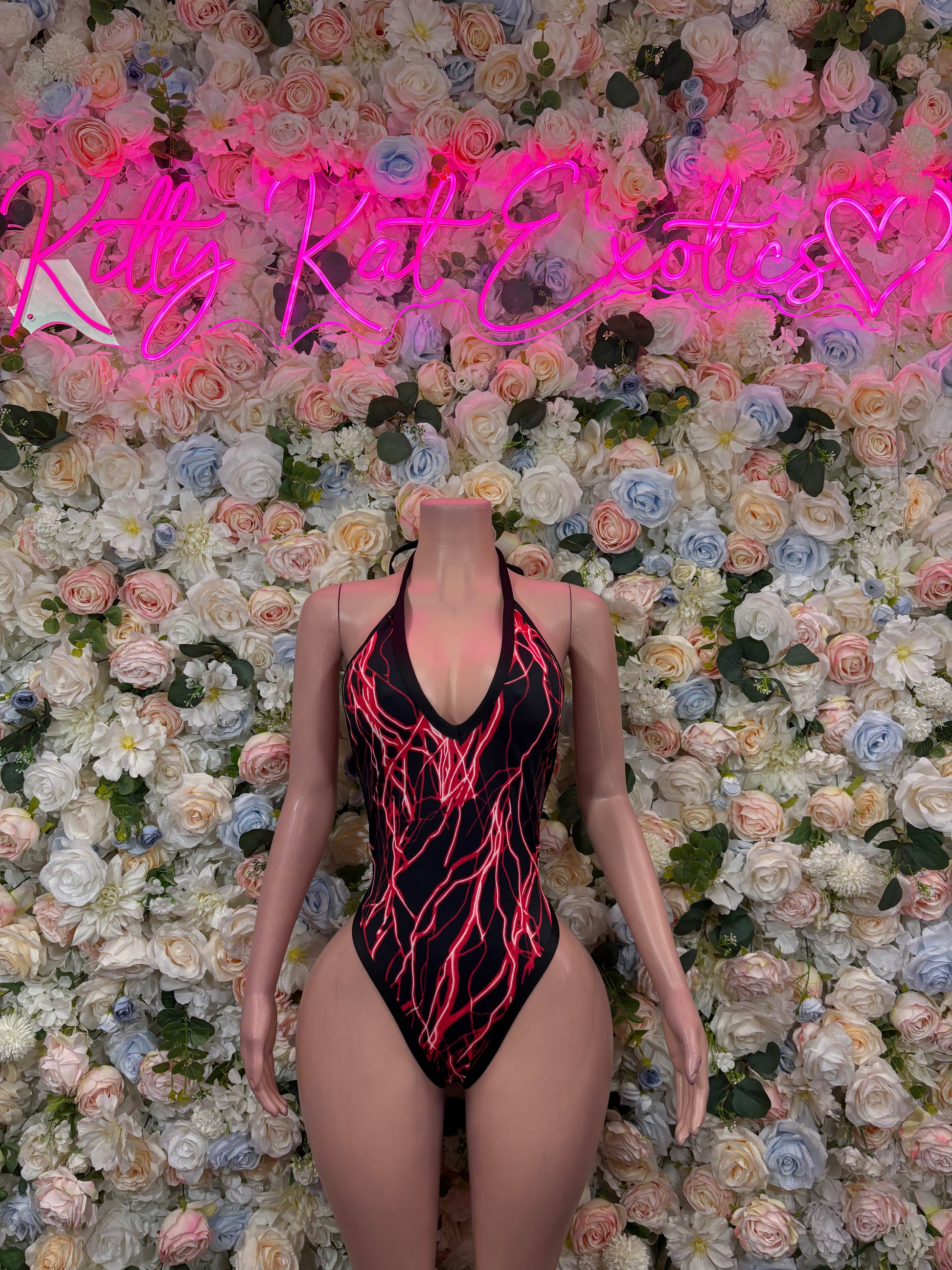 Red and black one-piece bodysuit with neon line print and deep V neckline