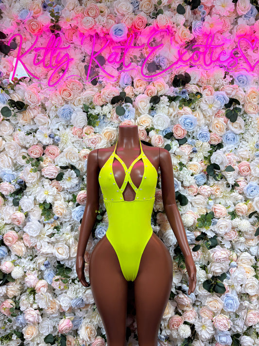 Neon green halter bodysuit with crisscross chest straps and high-cut legs