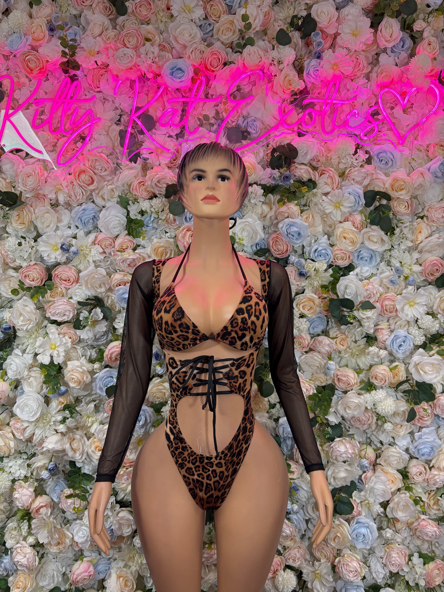 Leopard print bodysuit with black sheer long sleeves and lace-up front
