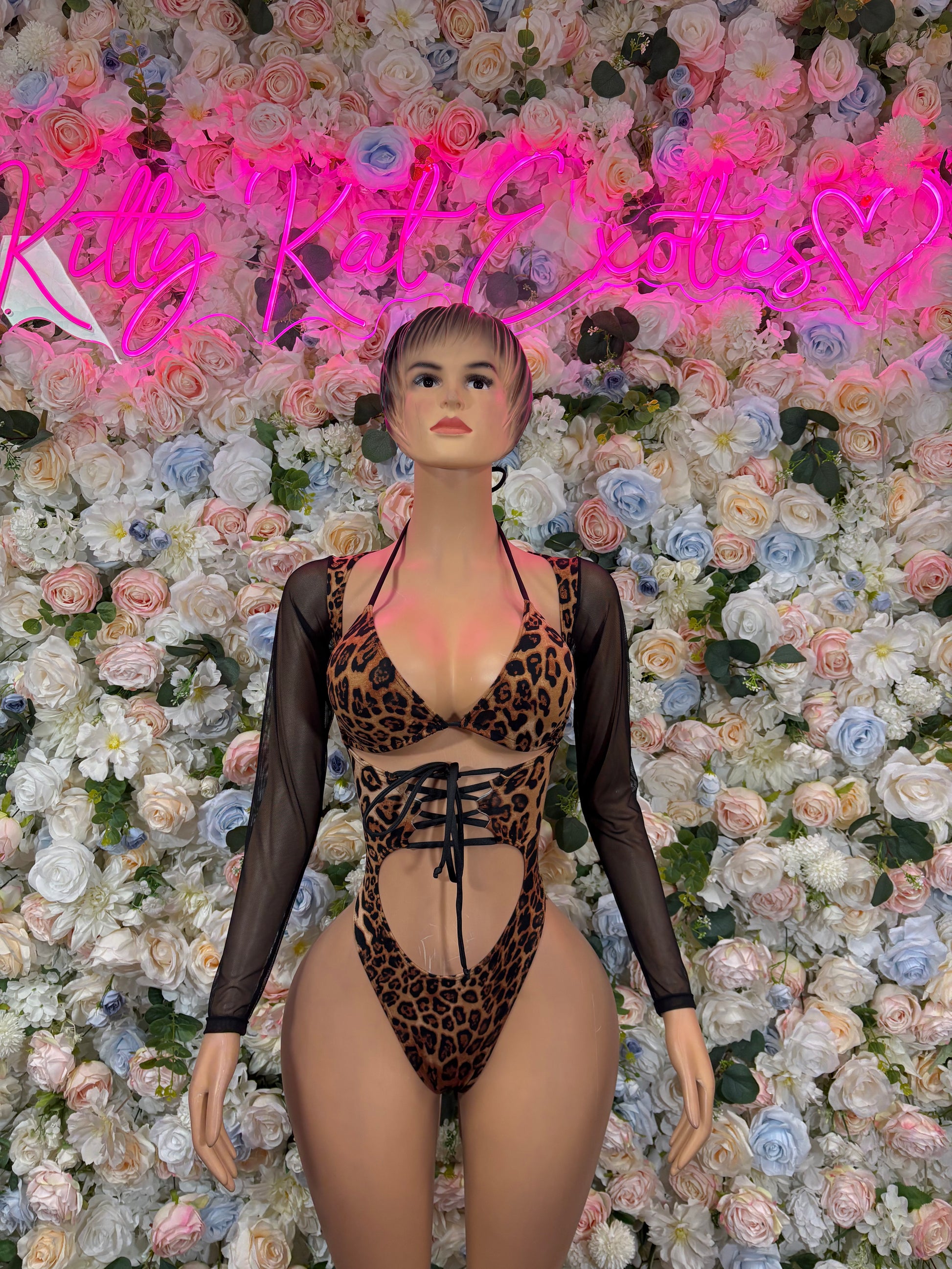 Leopard print bodysuit with black sheer long sleeves and lace-up front