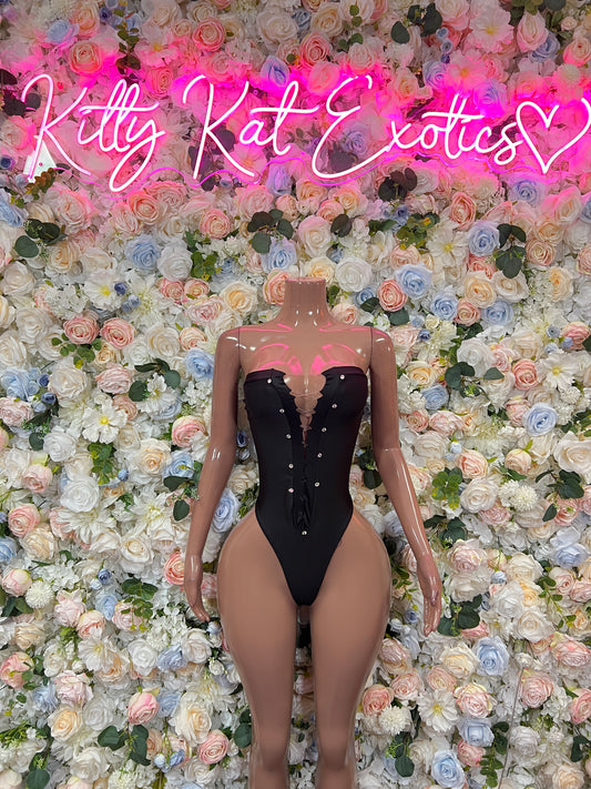 Black bustier-style bodysuit with button details and front thigh cutouts