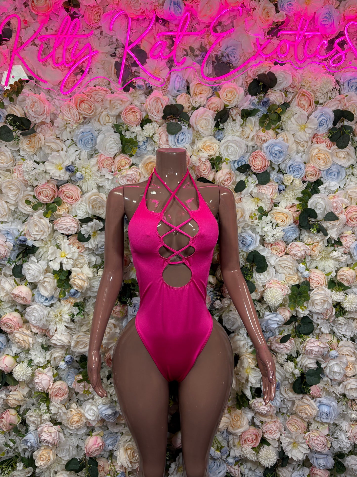Hot pink one-piece bodysuit with crisscross front lace-up neckline