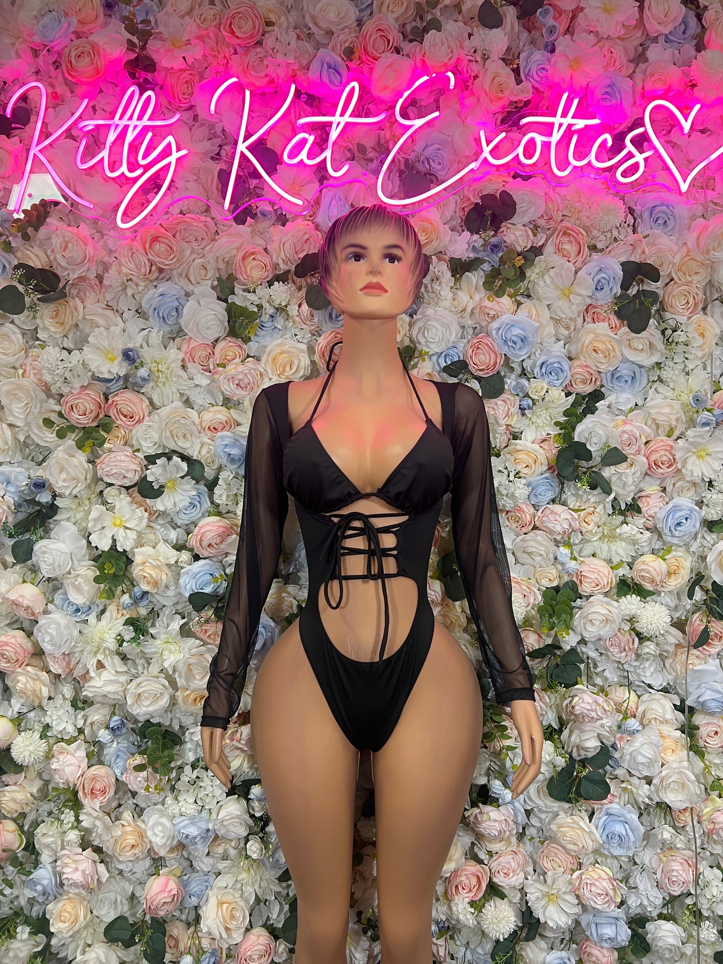 Black lace-up bodysuit with plunging neckline, open-back cutout, long sheer sleeves