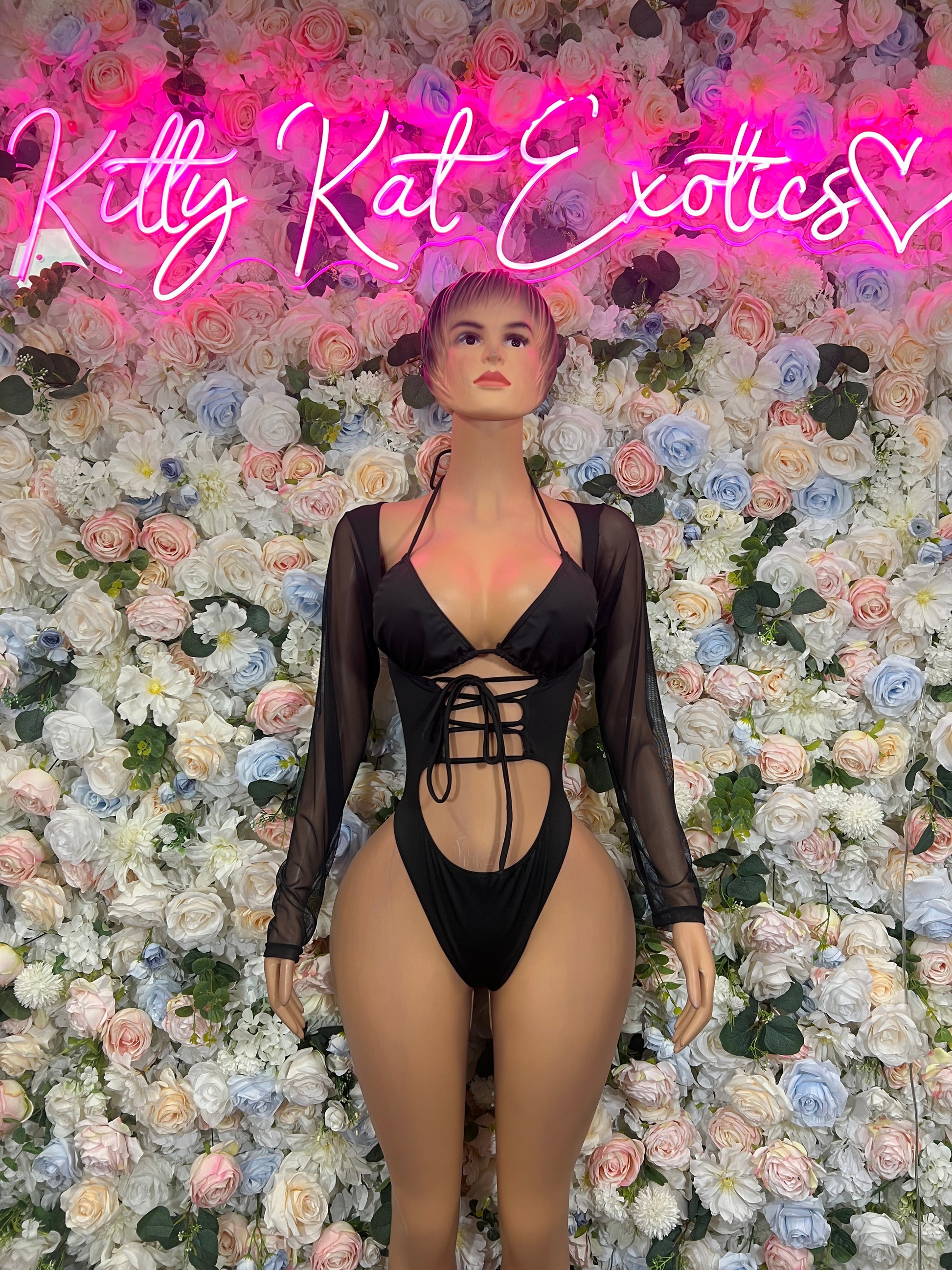 Black lace-up bodysuit with plunging neckline, open-back cutout, long sheer sleeves