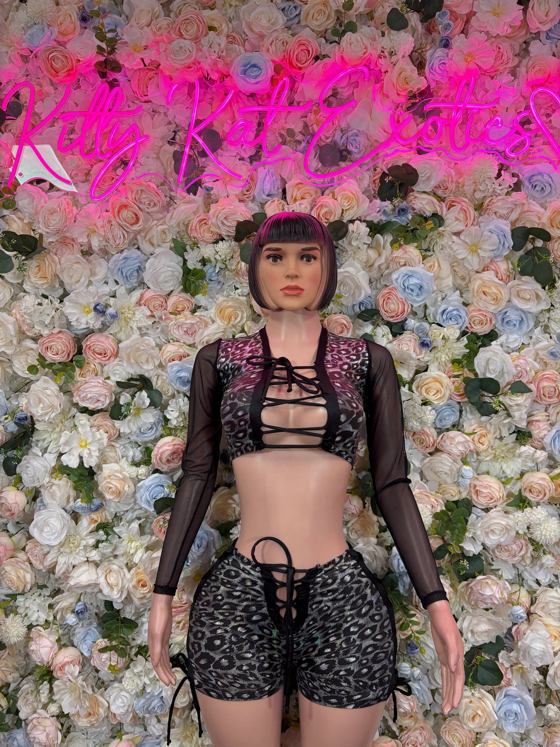 Black long-sleeve bodysuit with lace-up front, peacock-style print, high-cut shorts