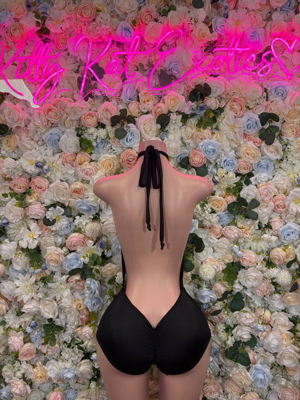 Black halter bodysuit with open back and center tie detail