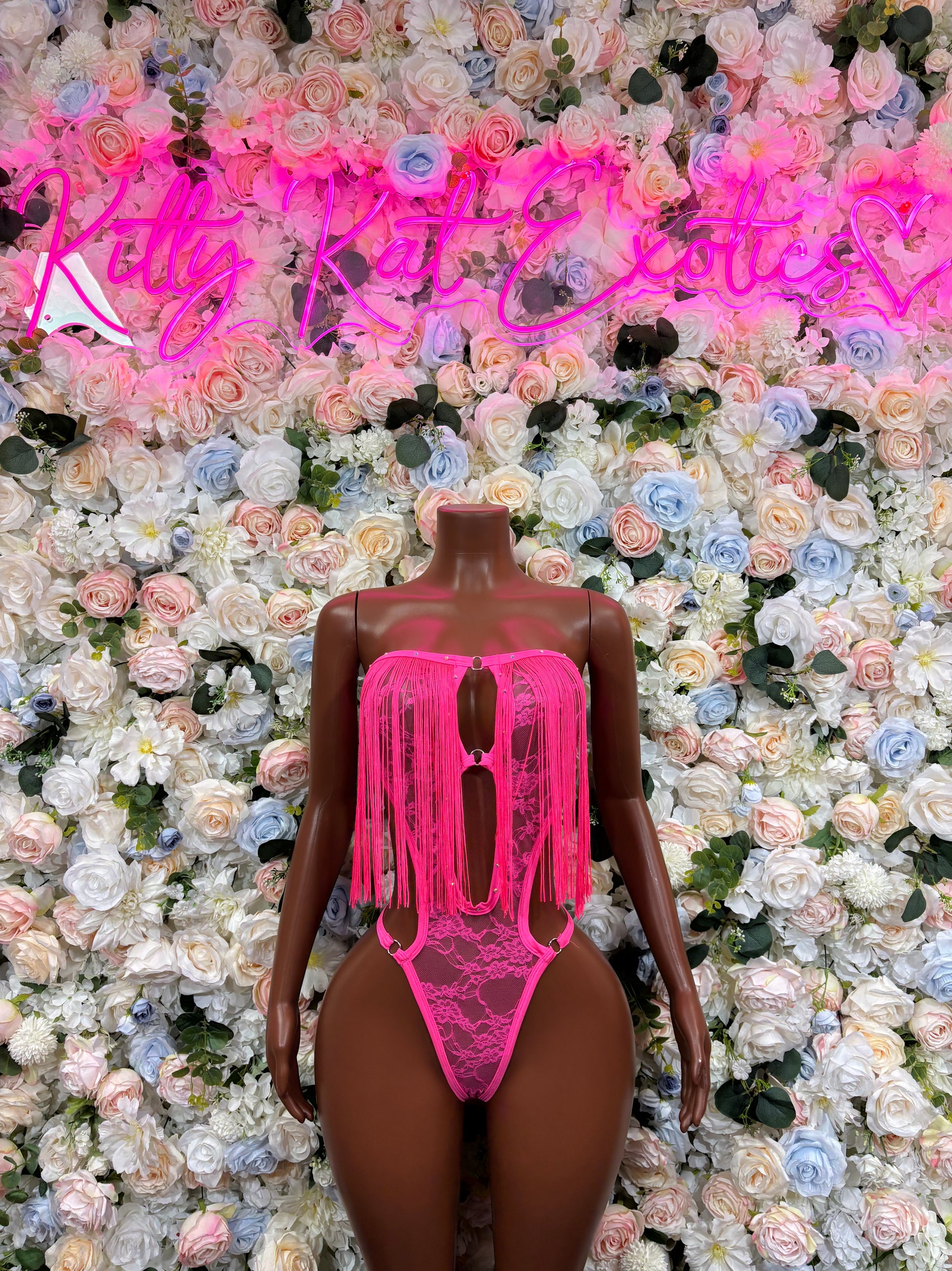 Hot pink strapless one-piece bodysuit with central fringe and side cutouts
