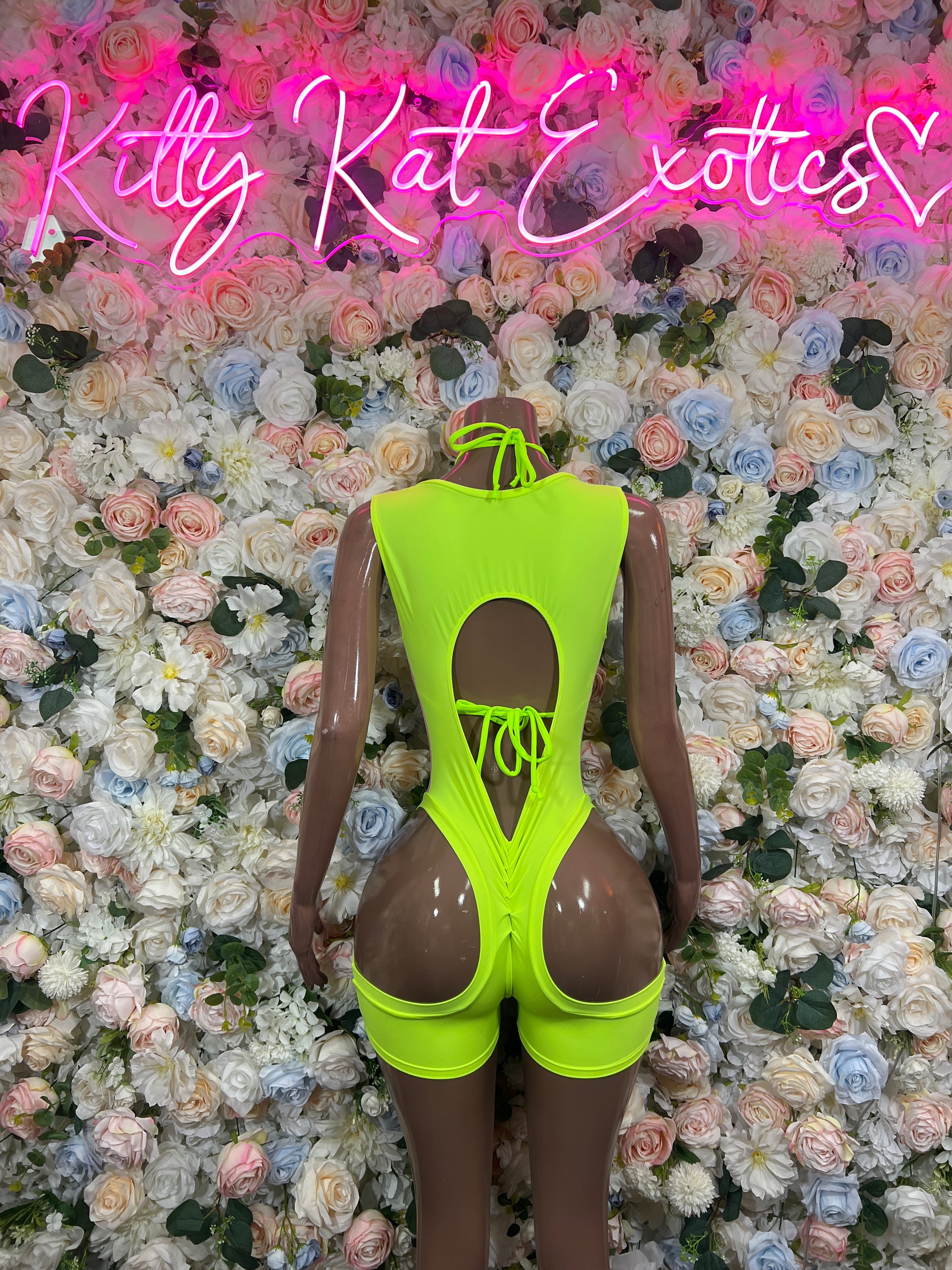 Neon green holographic lace-up bodysuit on mannequin, back keyhole with ties