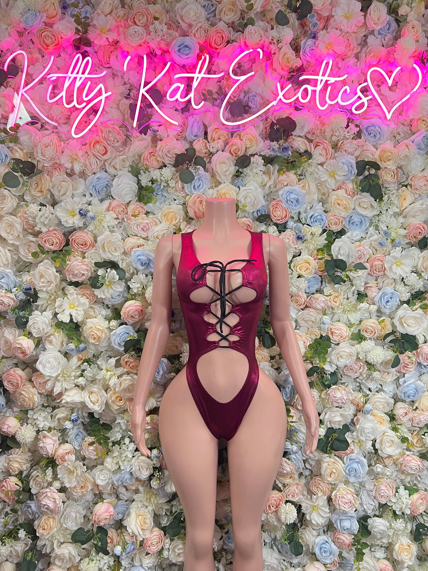 Burgundy lace-up bodysuit with deep neckline and cheeky cutout