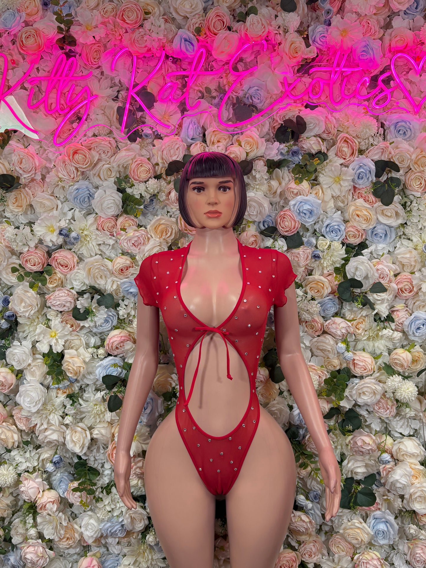 Red one-piece rave bodysuit with V-neck and dotted embellishments, high-cut bottom