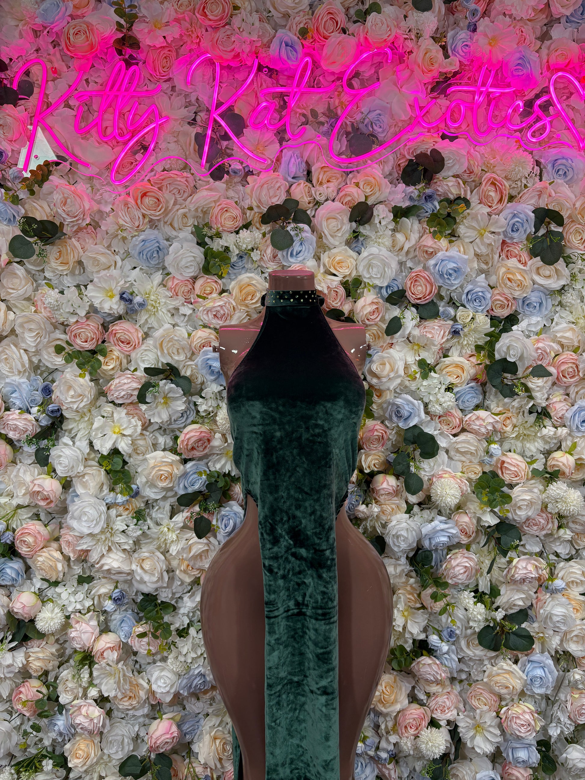 Dark green velvet maxi gown on mannequin, sleeveless high neckline