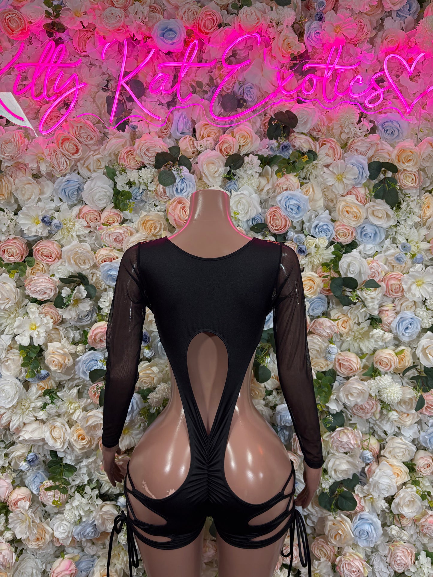 Leopard print bodysuit back view with black mesh long sleeves and center cutout