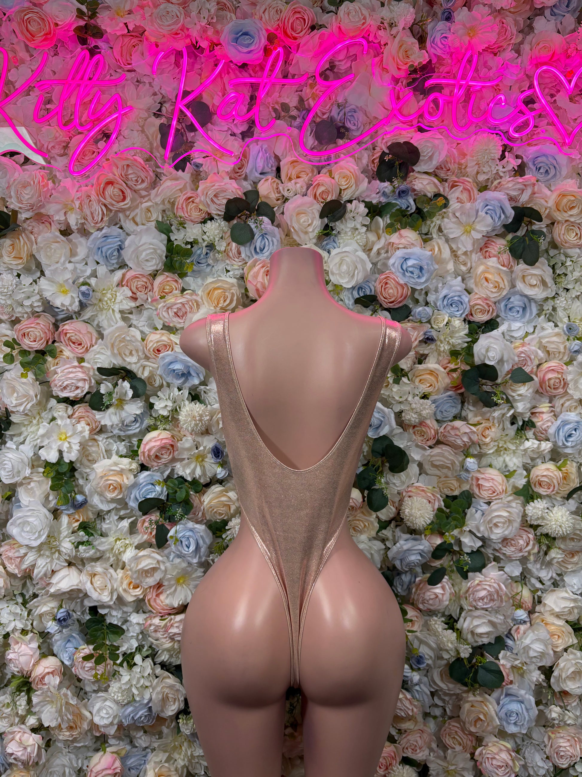 Tan dance bodysuit with open back and high-cut thong legs