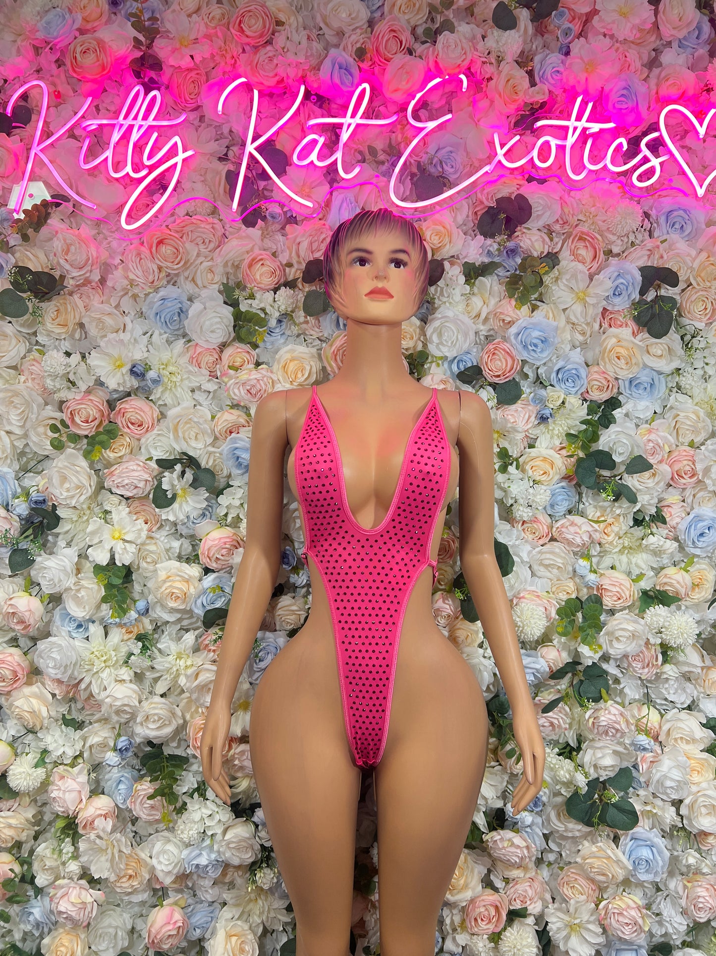 Pink rhinestone bodysuit with deep V-neck, slim one-piece fit