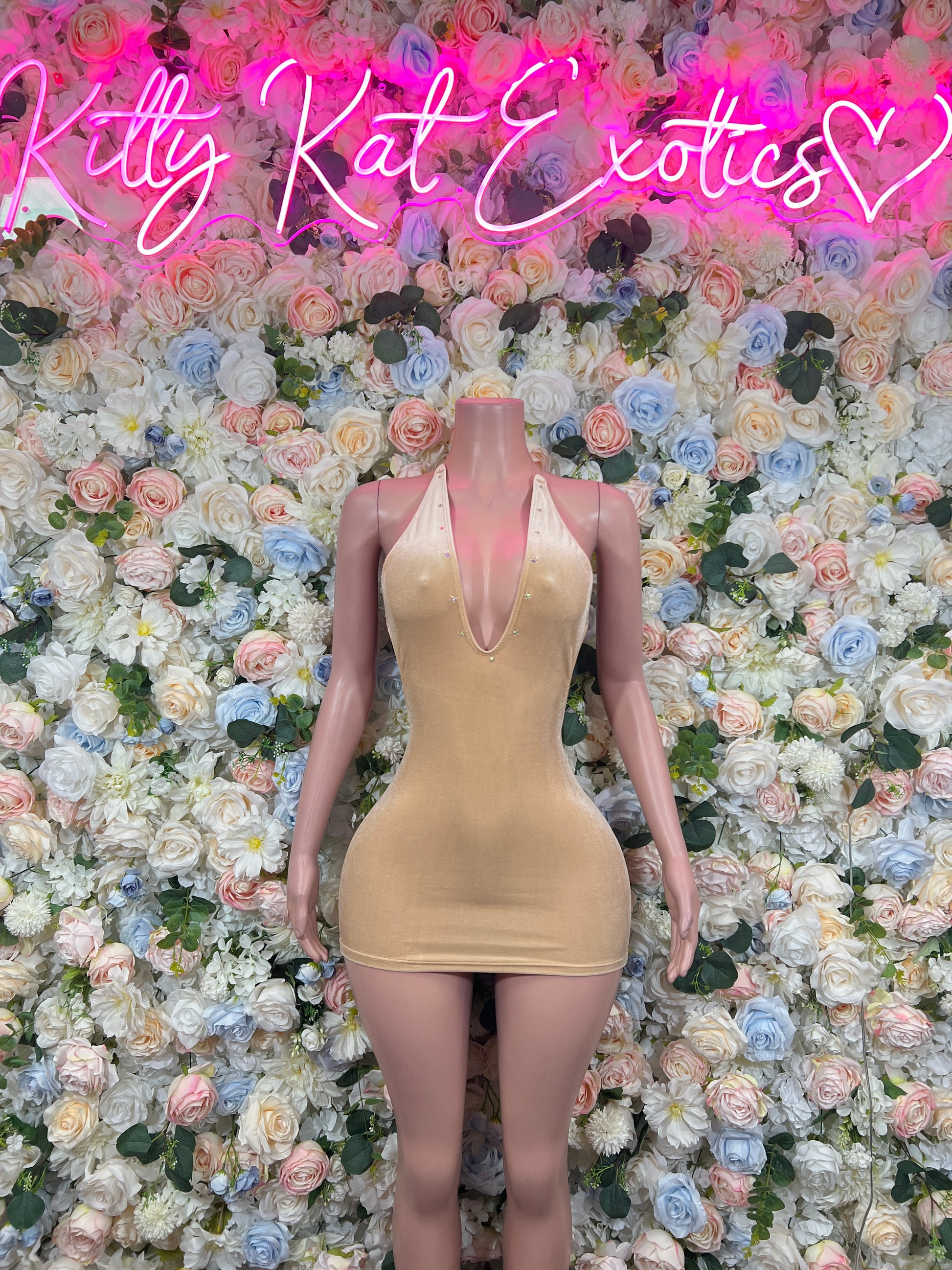Beige fitted mini dress with sheer V-neck and short silhouette