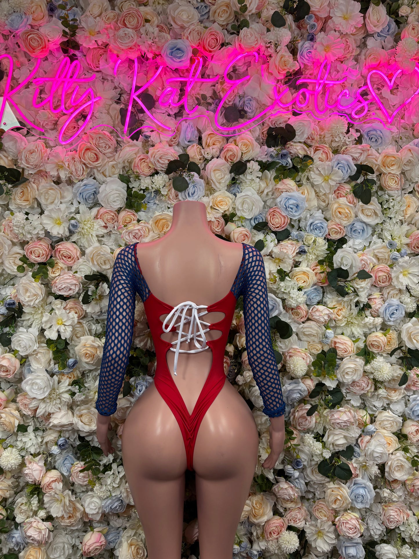 Red bodysuit with white lace-up front, blue mesh sleeves, scoop chest cutout