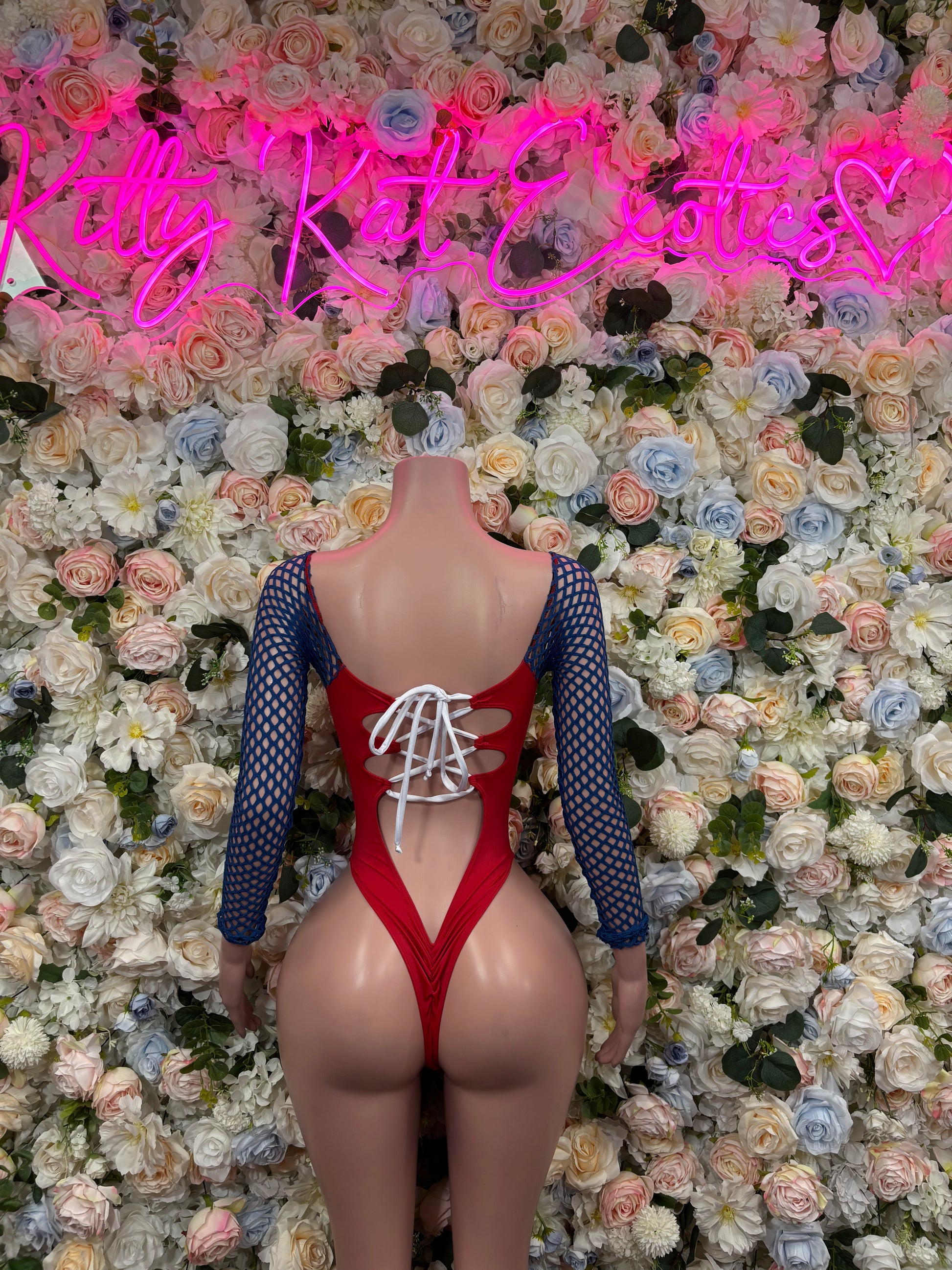 Red bodysuit with white lace-up front, blue mesh sleeves, scoop chest cutout
