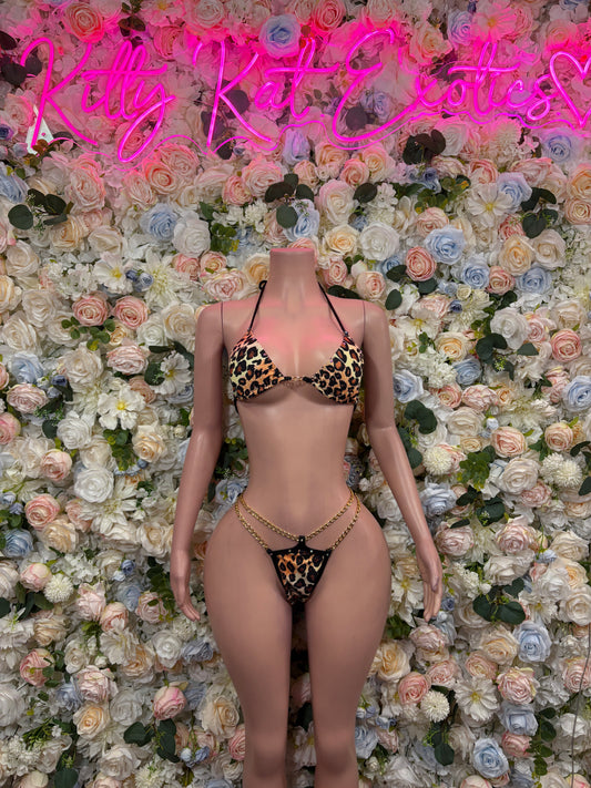 Two-piece bodysuit set with leopard print triangle cups and tie-back string bottoms.