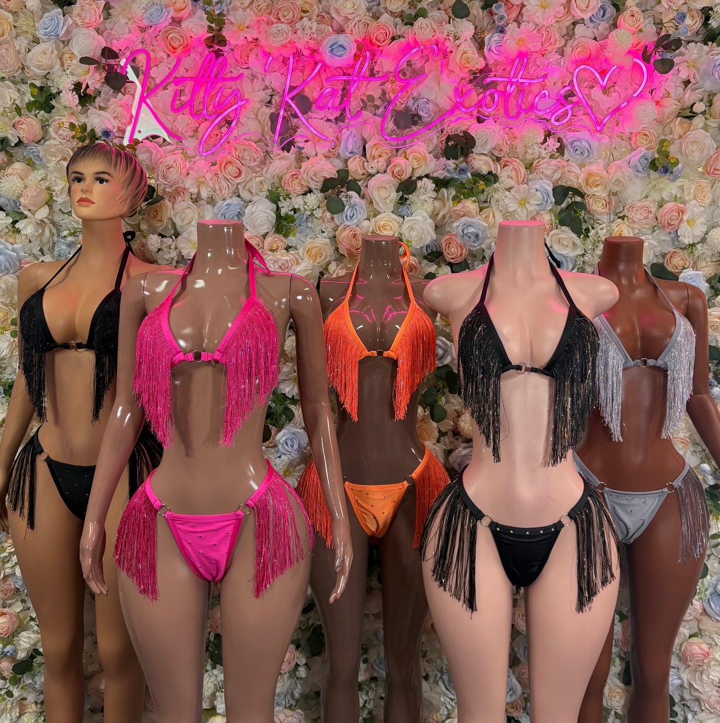 Orange fringe two-piece bikini set on mannequins, halter top and tassel bottoms