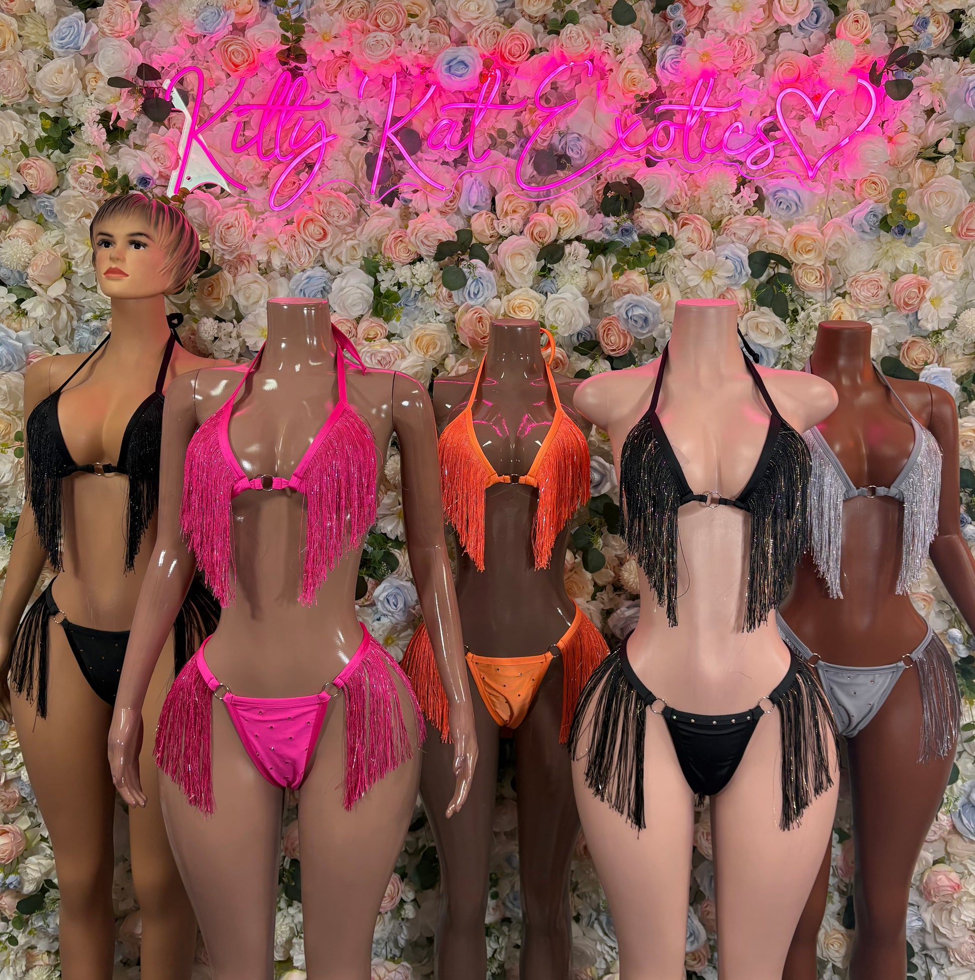 Orange fringe two-piece bikini set on mannequins, halter top and tassel bottoms