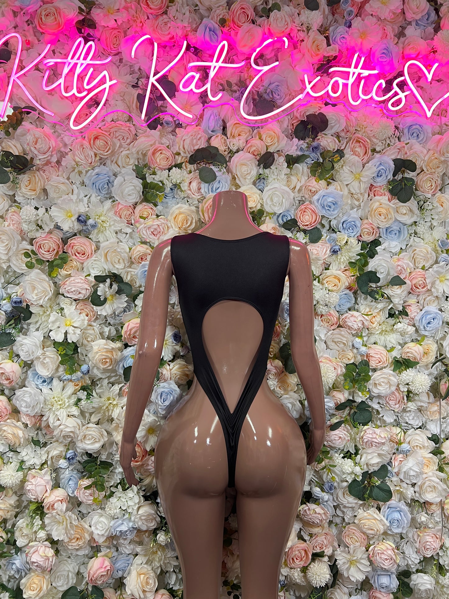 Back view: black mesh one-piece bodysuit with red lightning print and lower-back cutout
