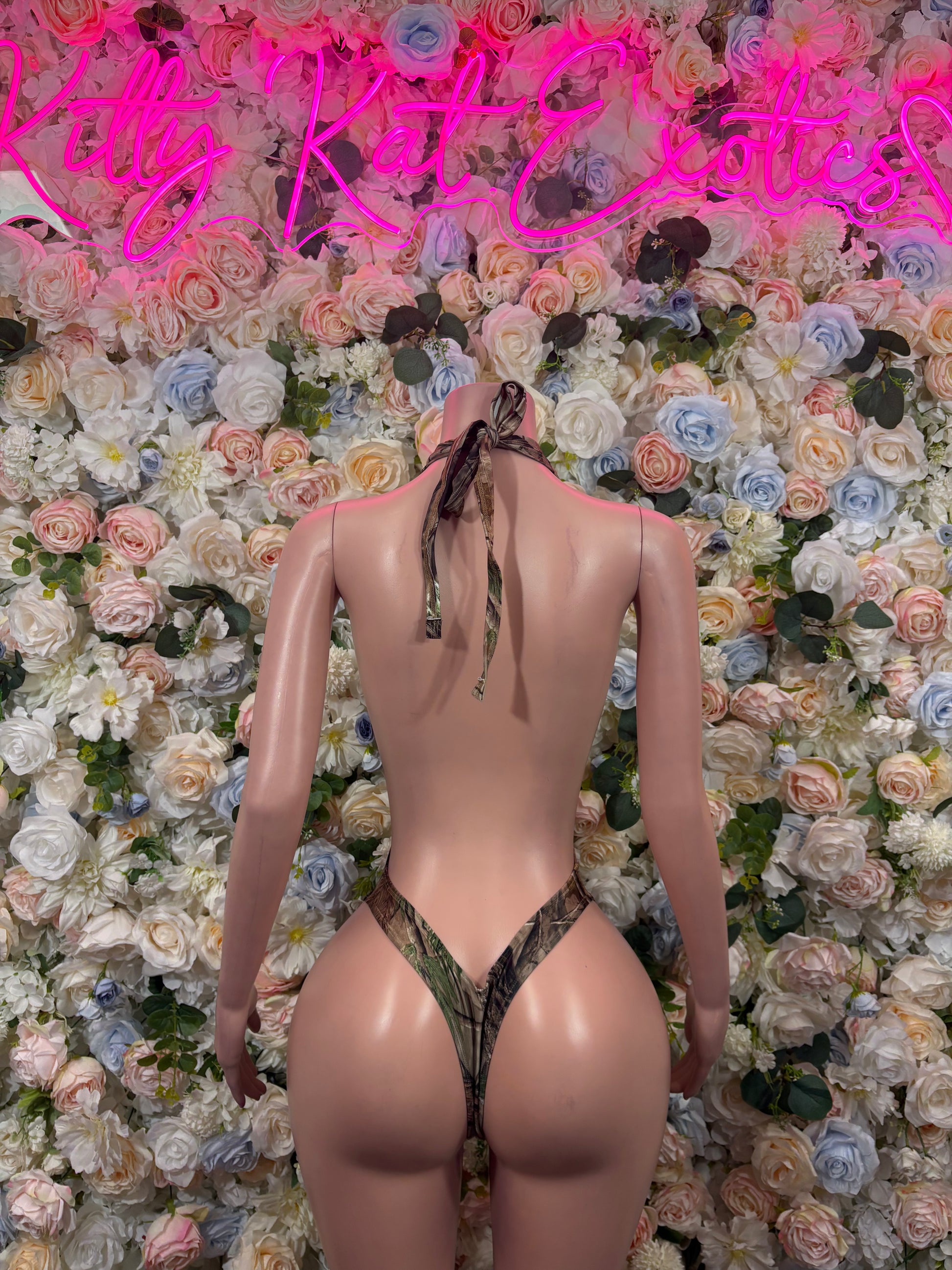 Camo-print thong bodysuit with open back, back ties, and halter strap