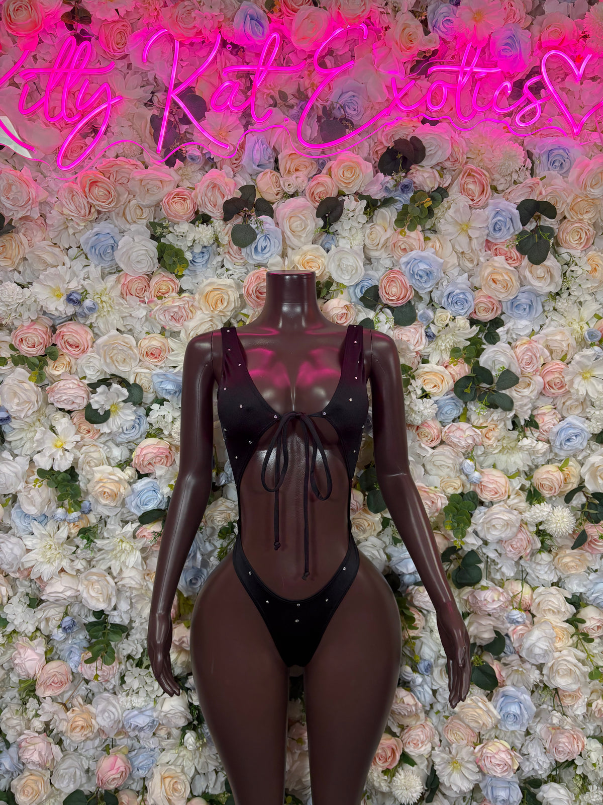 Black plunging bodysuit with tie-front halter neckline and thong-style bottom