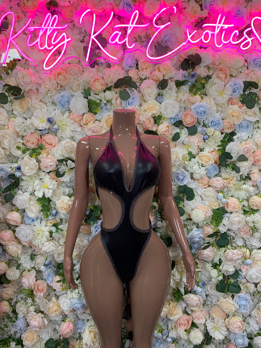 Black latex one-piece bodysuit with plunging neckline and central cutout panels