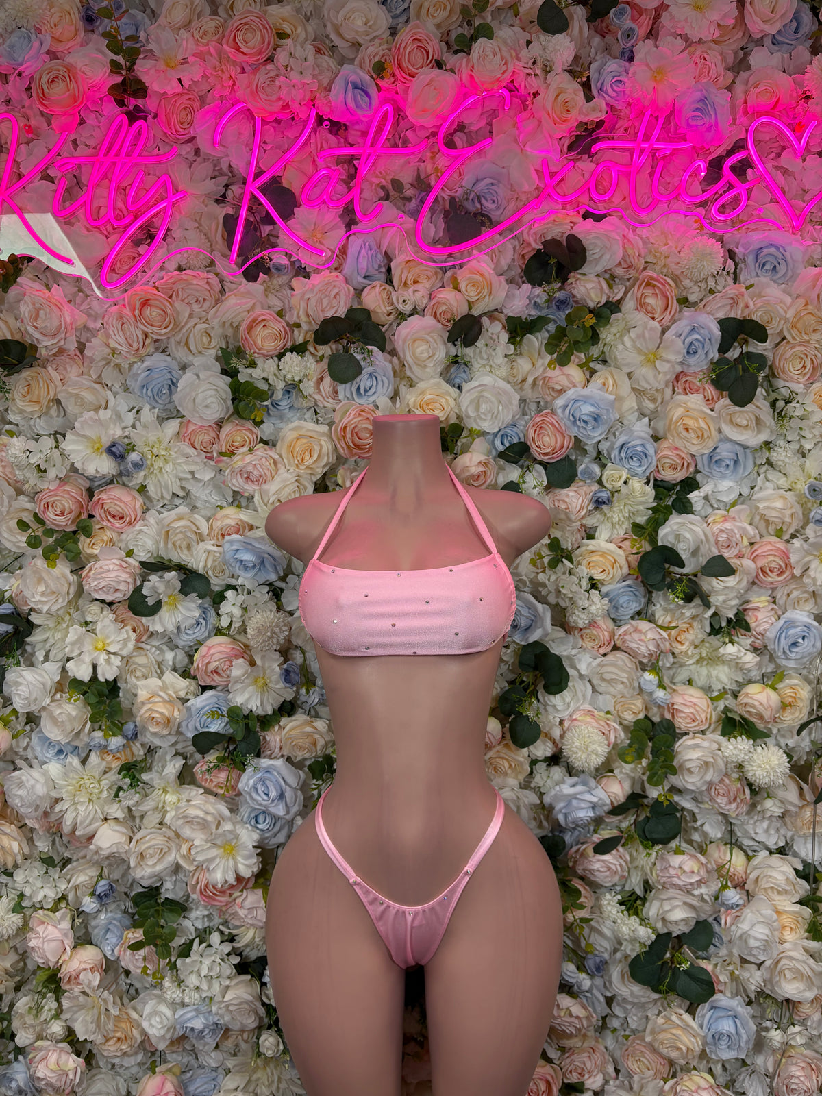 Pink two-piece lingerie set with halter bra and high-cut string bottoms