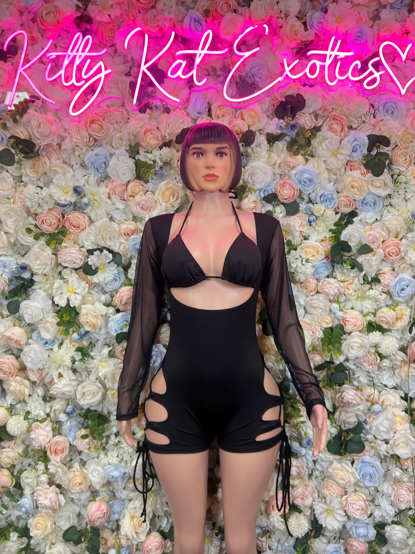 Black bodysuit with sheer sleeves, deep V neckline, lace-up cutout detail