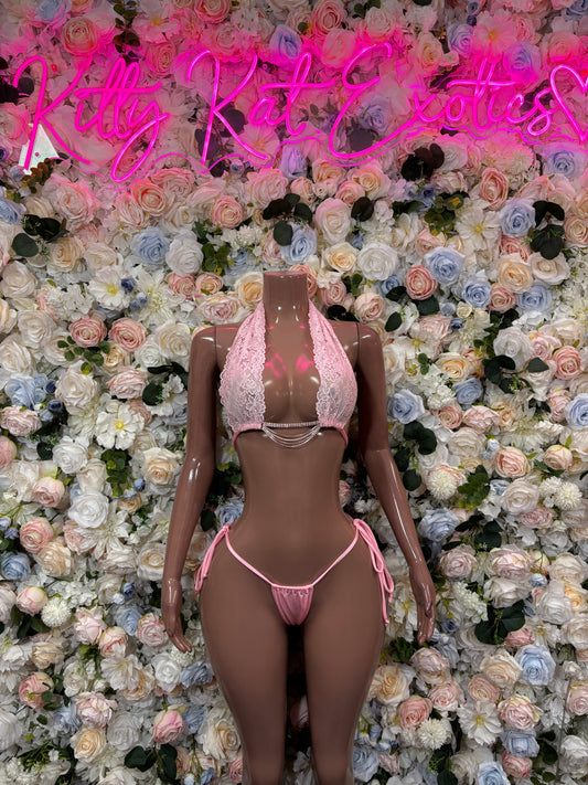 Baby pink two-piece bikini with triangle top, tie-front bottom, and lace trim