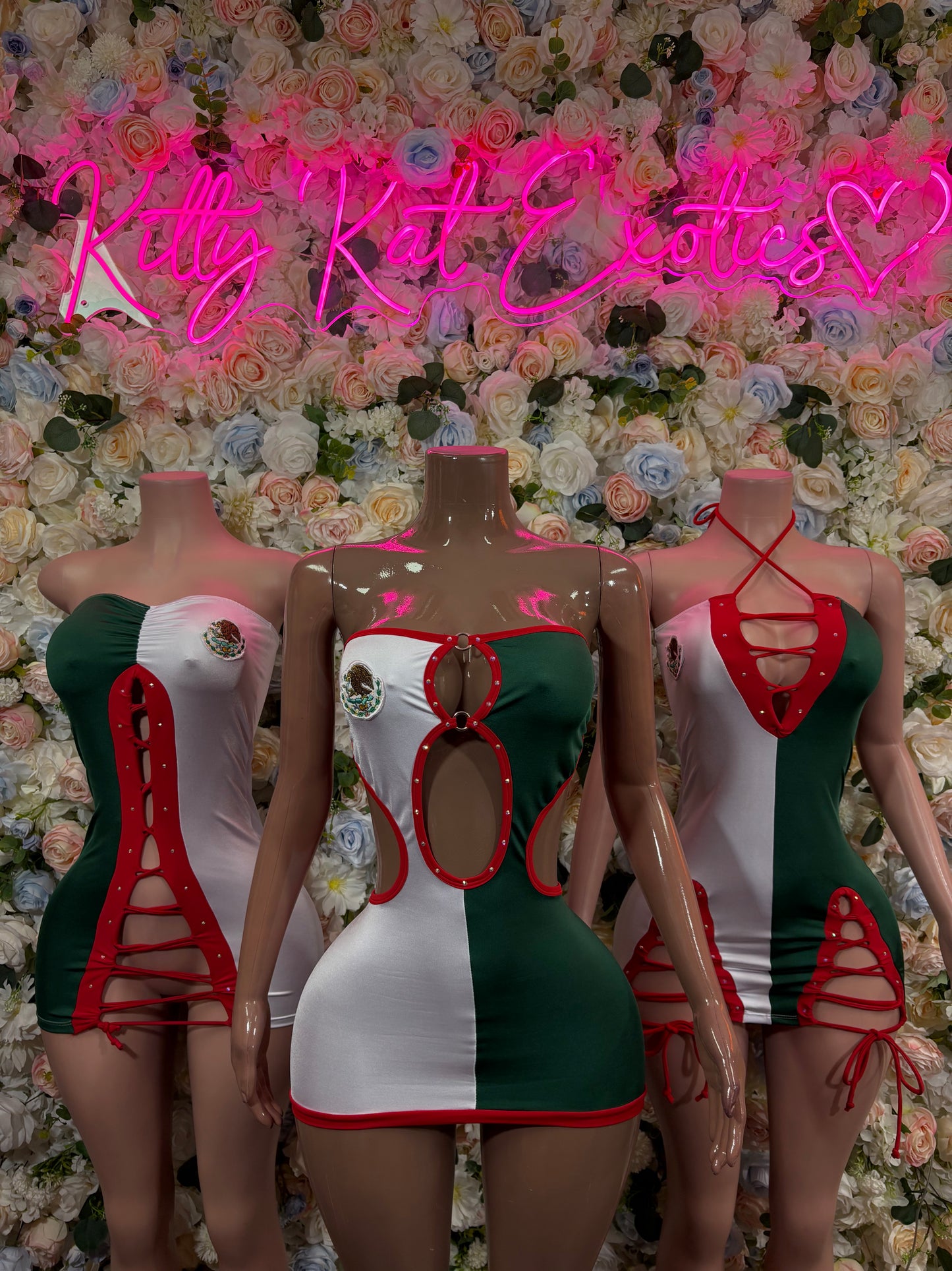 Three mini dresses in green, white, and red with cutout strap details.