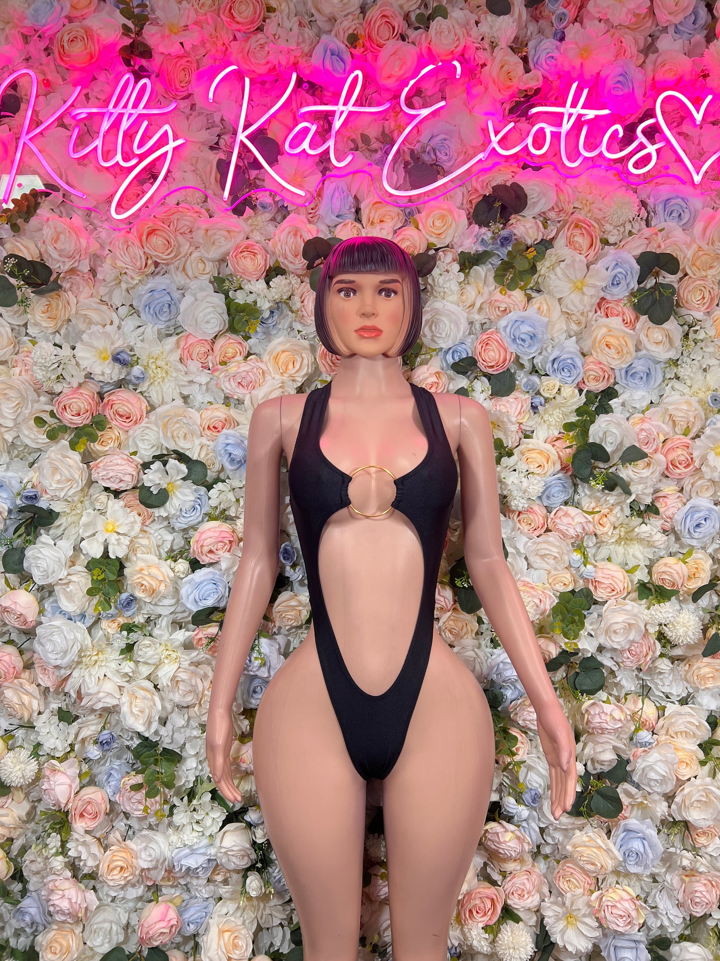 Black halter bodysuit with chest ring detail and open back cutout