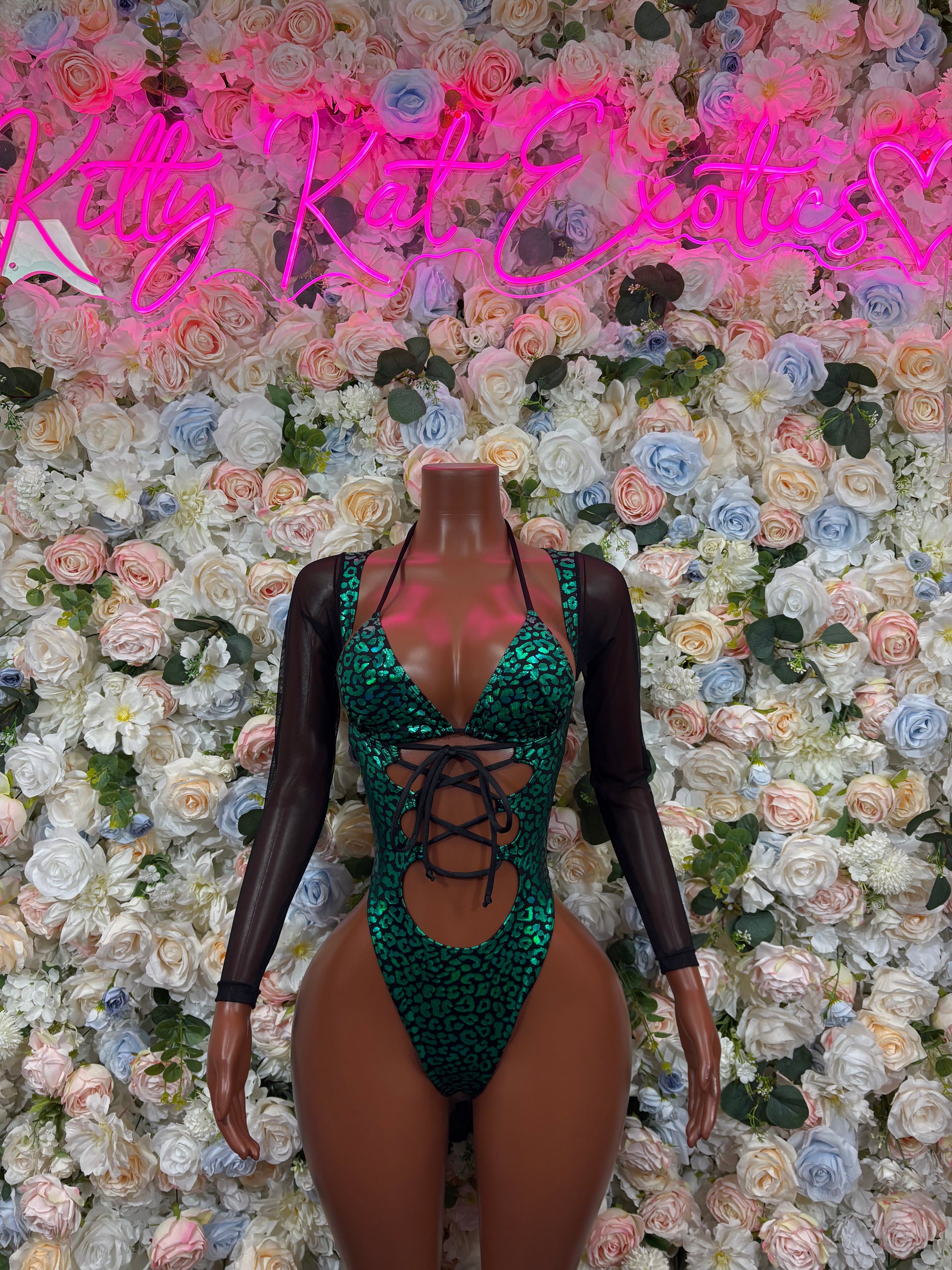 Green cheetah one-piece bodysuit with crisscross lace-up front and sheer long sleeves