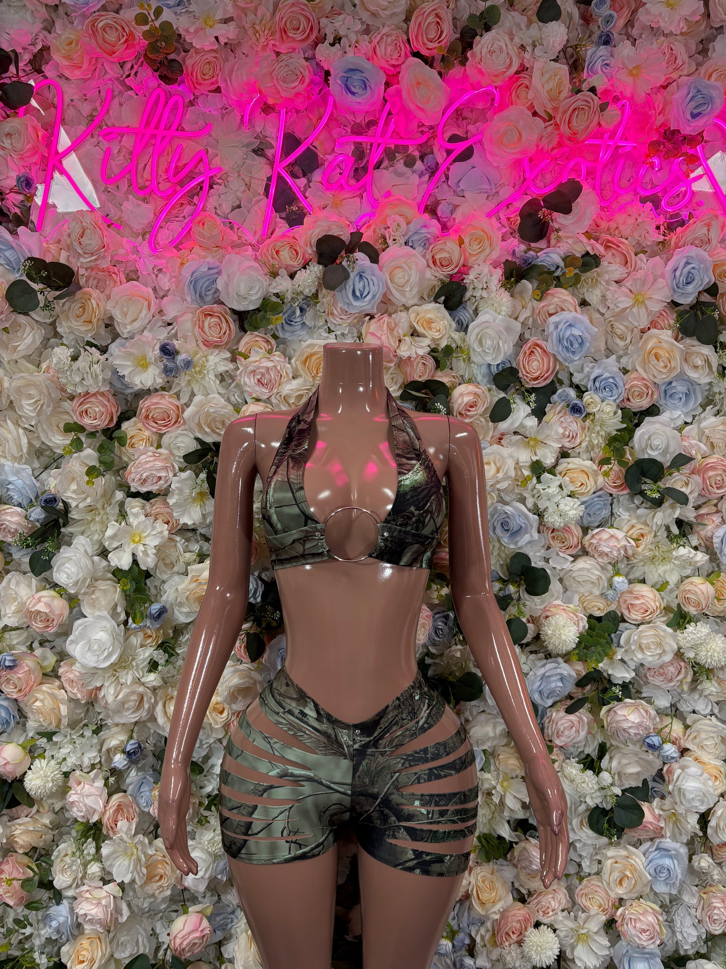 Camo-print two-piece dancewear set with green bra and matching short shorts, black lace tie