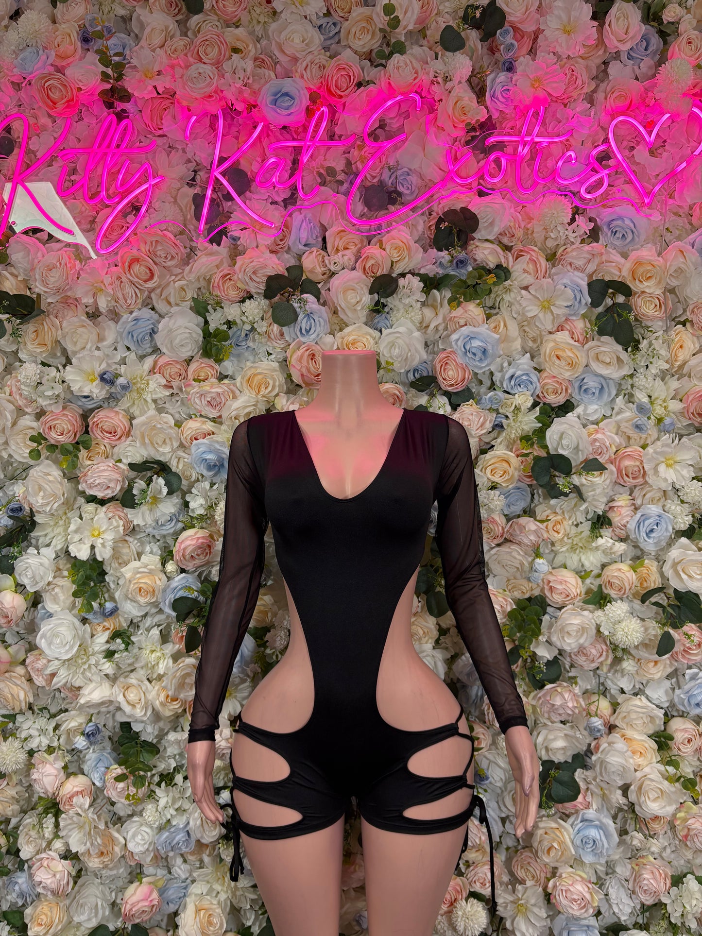 Black long-sleeve bodysuit with V-neck and midriff cutouts, thong back