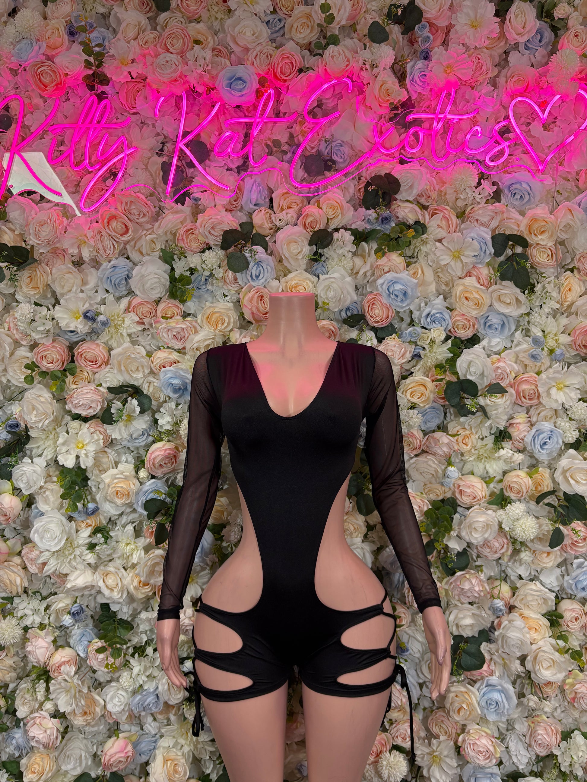 Black long-sleeve bodysuit with V-neck and midriff cutouts, thong back