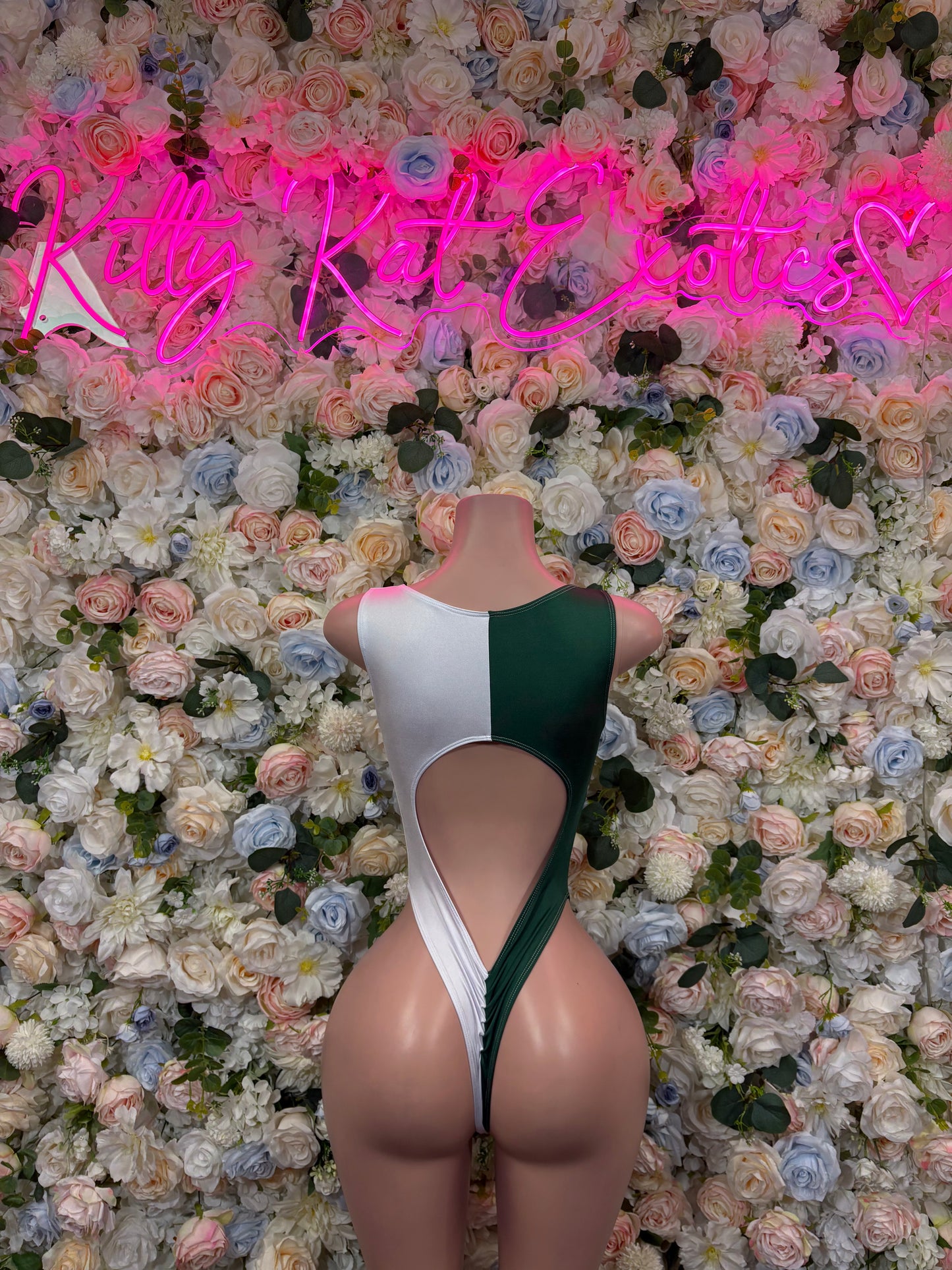 Red, white, and green one-piece bodysuit with crisscross lace-up back