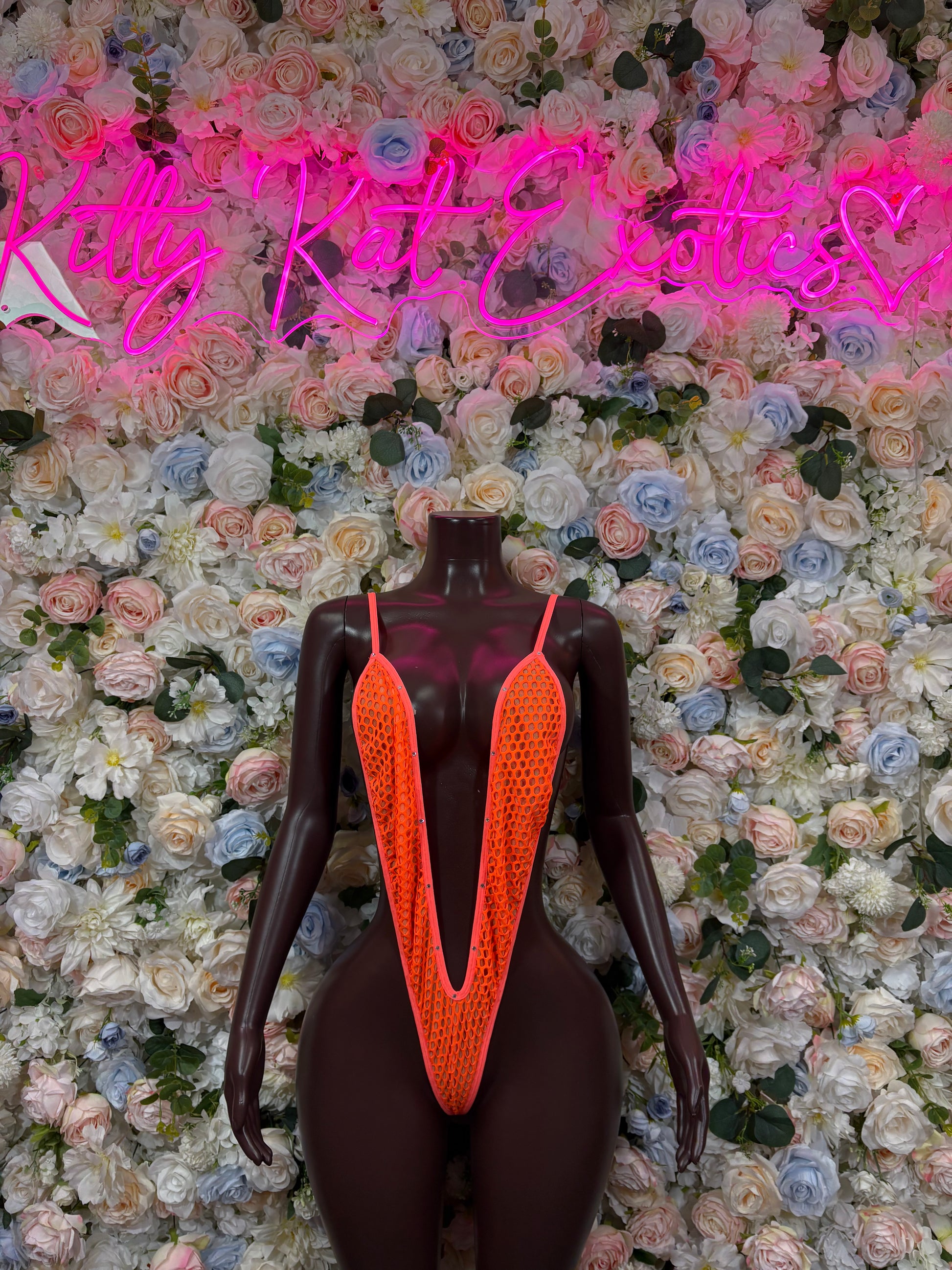 Orange slingshot one-piece bodysuit with V-neck mesh front and thin straps