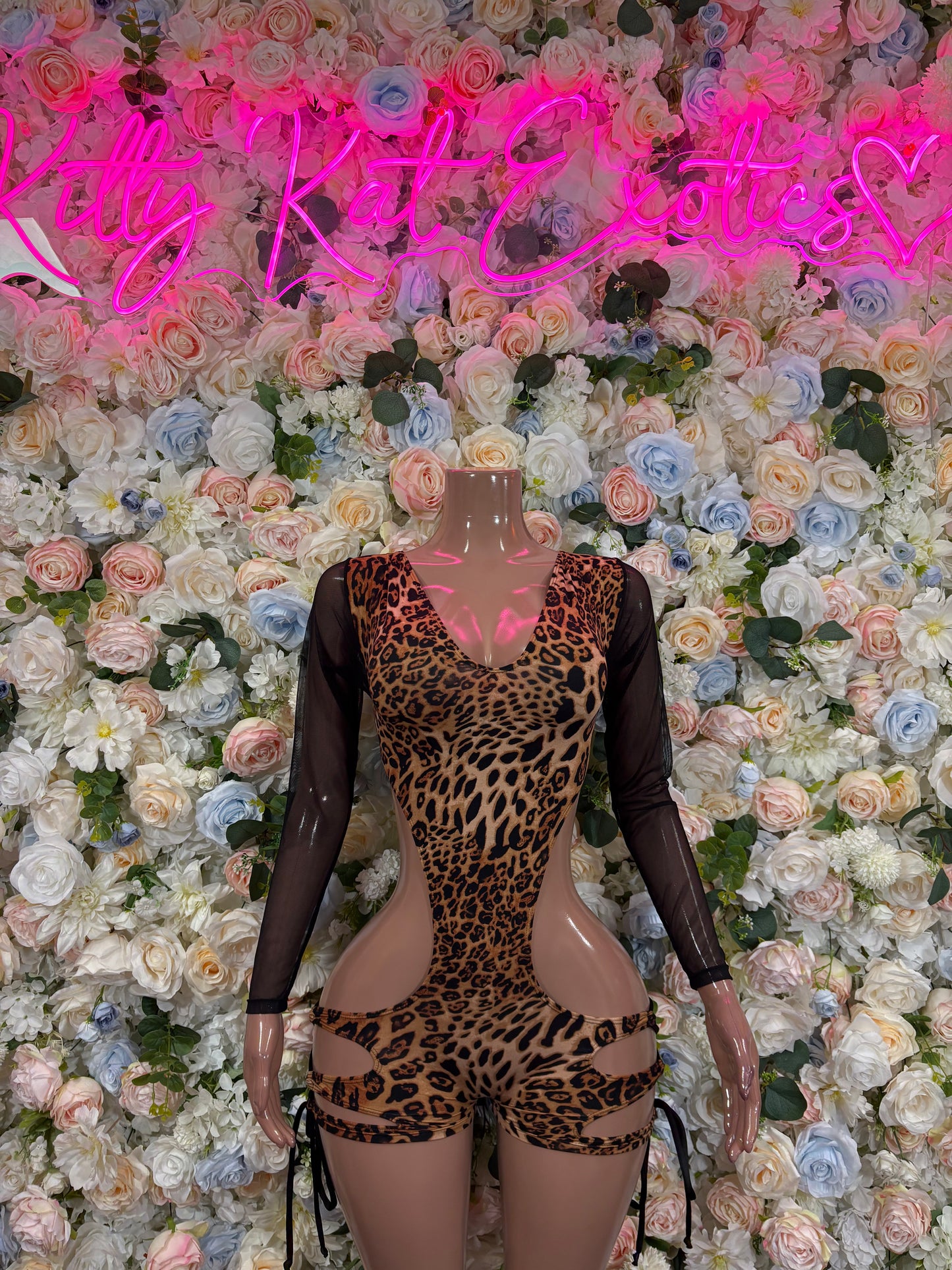 Leopard print bodysuit with black mesh long sleeves and plunging neckline