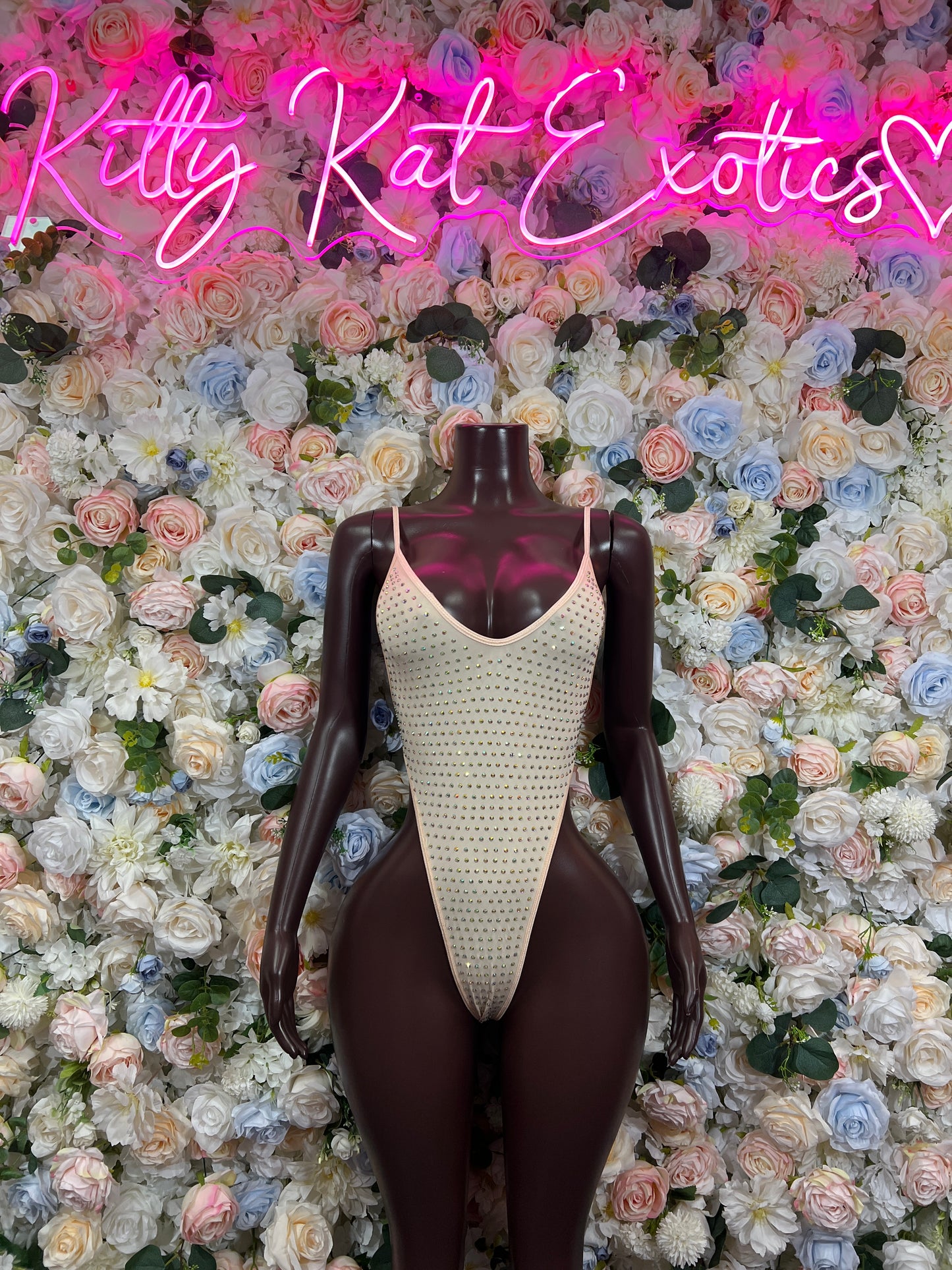Nude rhinestone one-piece bodysuit with scoop neckline and high-cut leg openings
